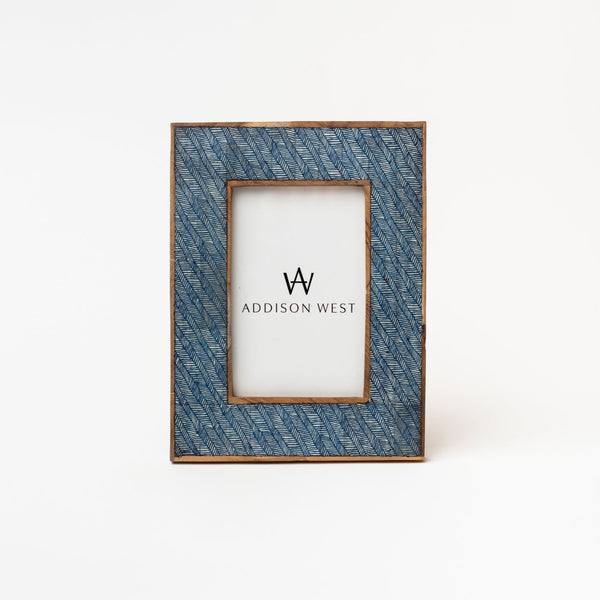 Blue textured picture frame with brown edge on a white  backgroundTwo's company blue Shibori Basketweave Picture Frame on a white background