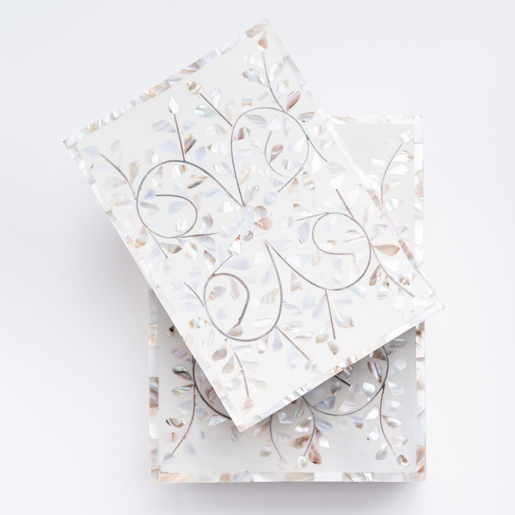 Top of mother of pearl inlay boxes in two sizes stacked on a white background from above from Addison West home goods