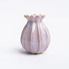 Small  pink sculpted bud vase on white background