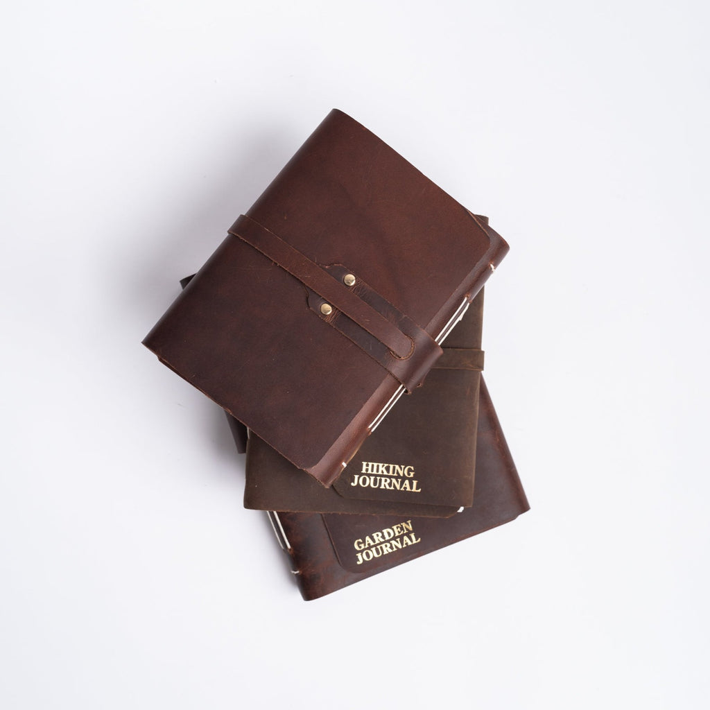 Handmade leather journals from above on white background