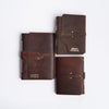 Handmade leather journals from above on white background