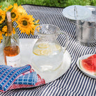 Bubble Glass Pitcher on a white tray on a picnic blanket at Addison West