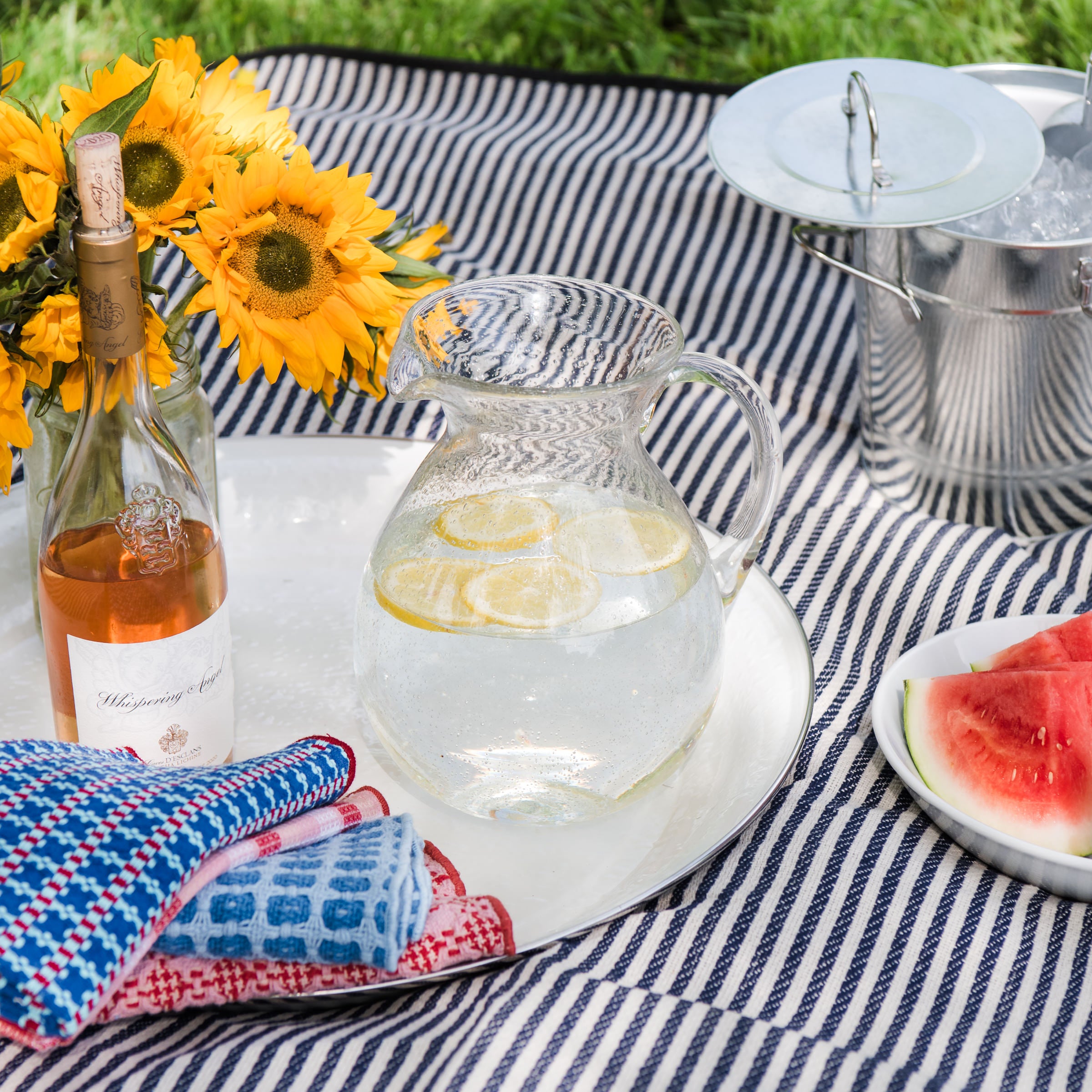 Bubble Glass Pitcher on a white tray on a picnic blanket at Addison West