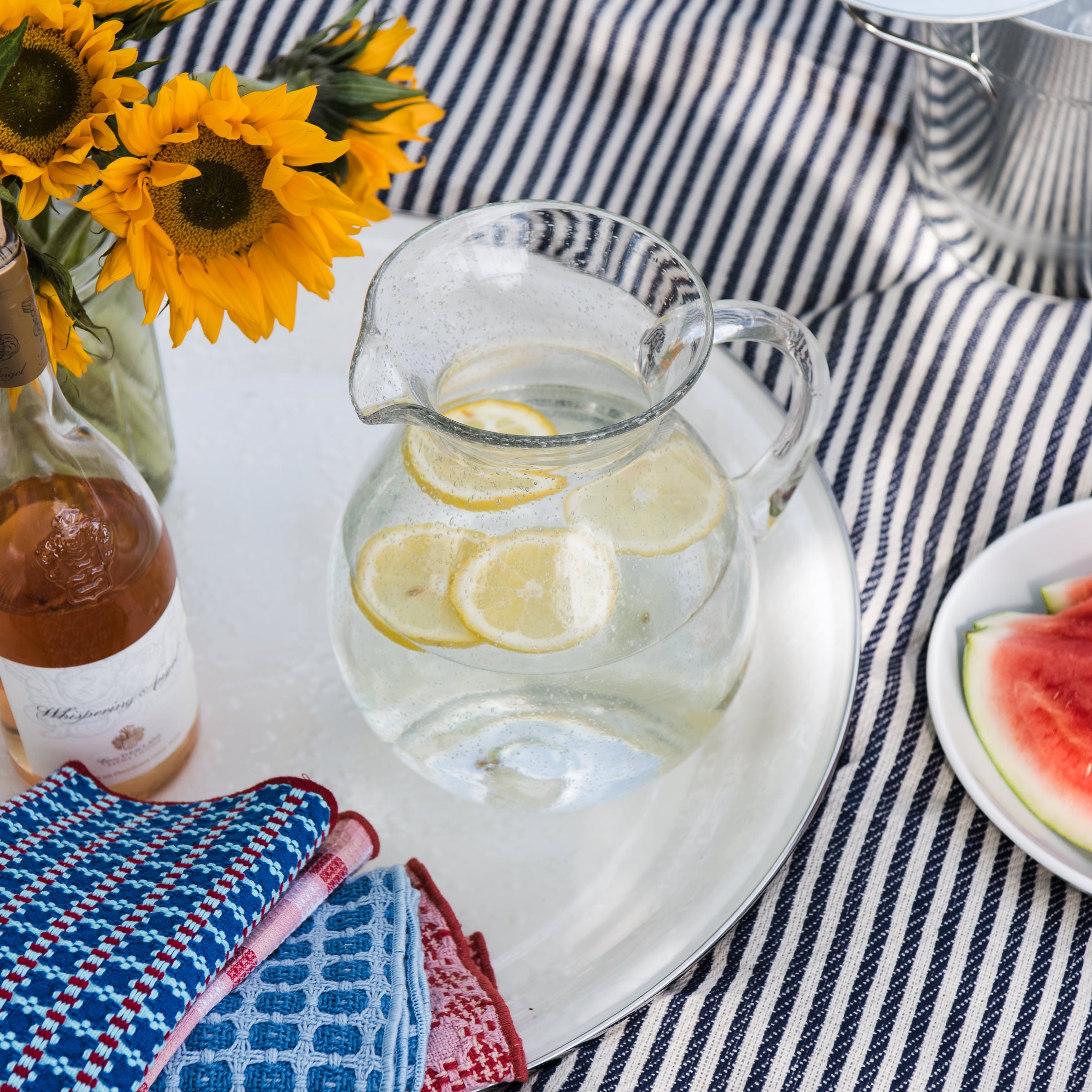 Bubble Glass Pitcher on a white tray on a picnic blanket at Addison West
