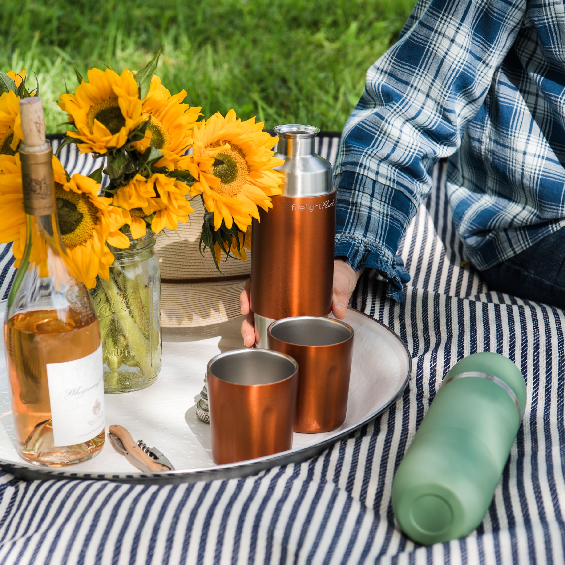 High Camp Firelight Flask in Copper on a picnic blanket with a model at Addison West