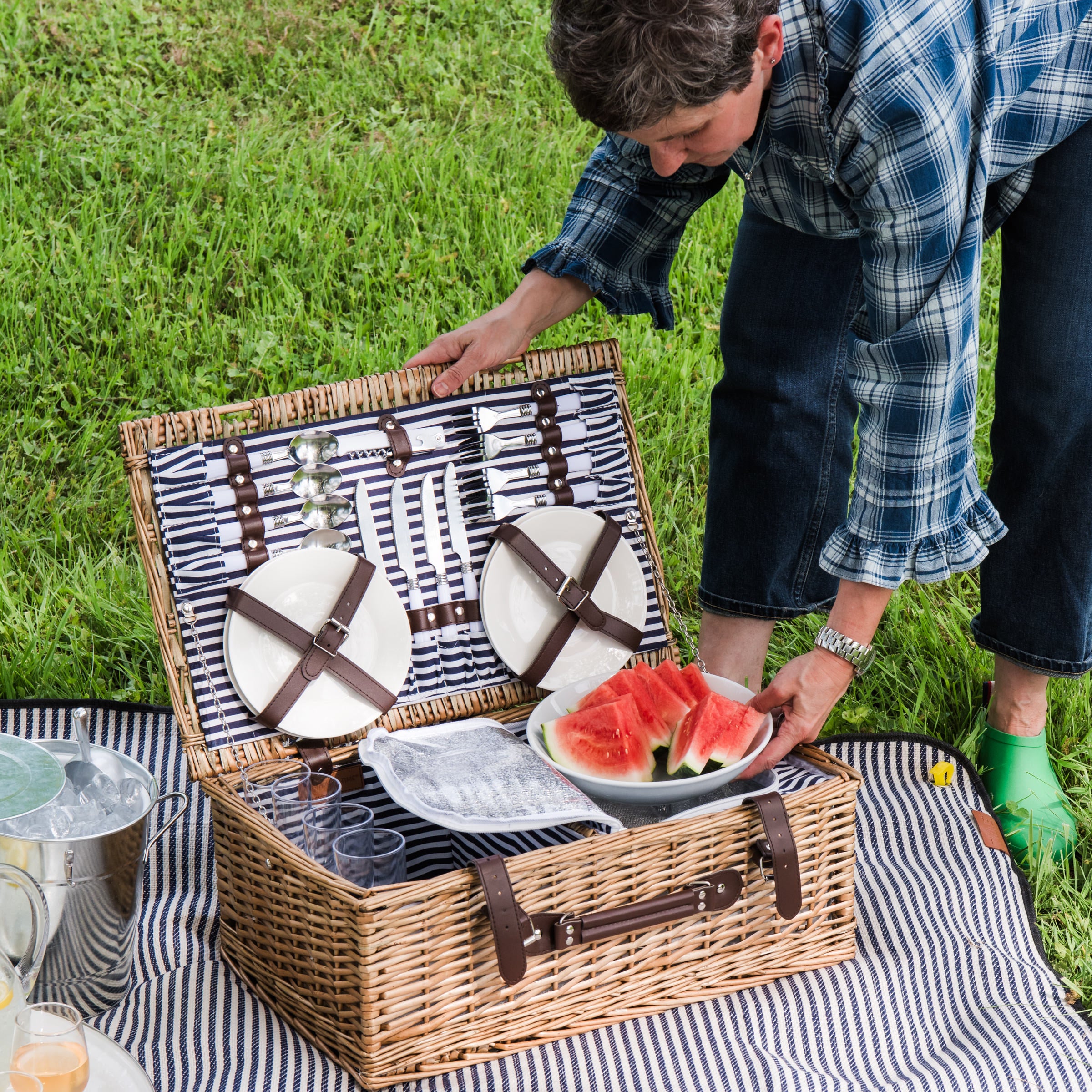 Covington Classic Willow Four Person Picnic Basket on a picnic blanket with a model at Addison West