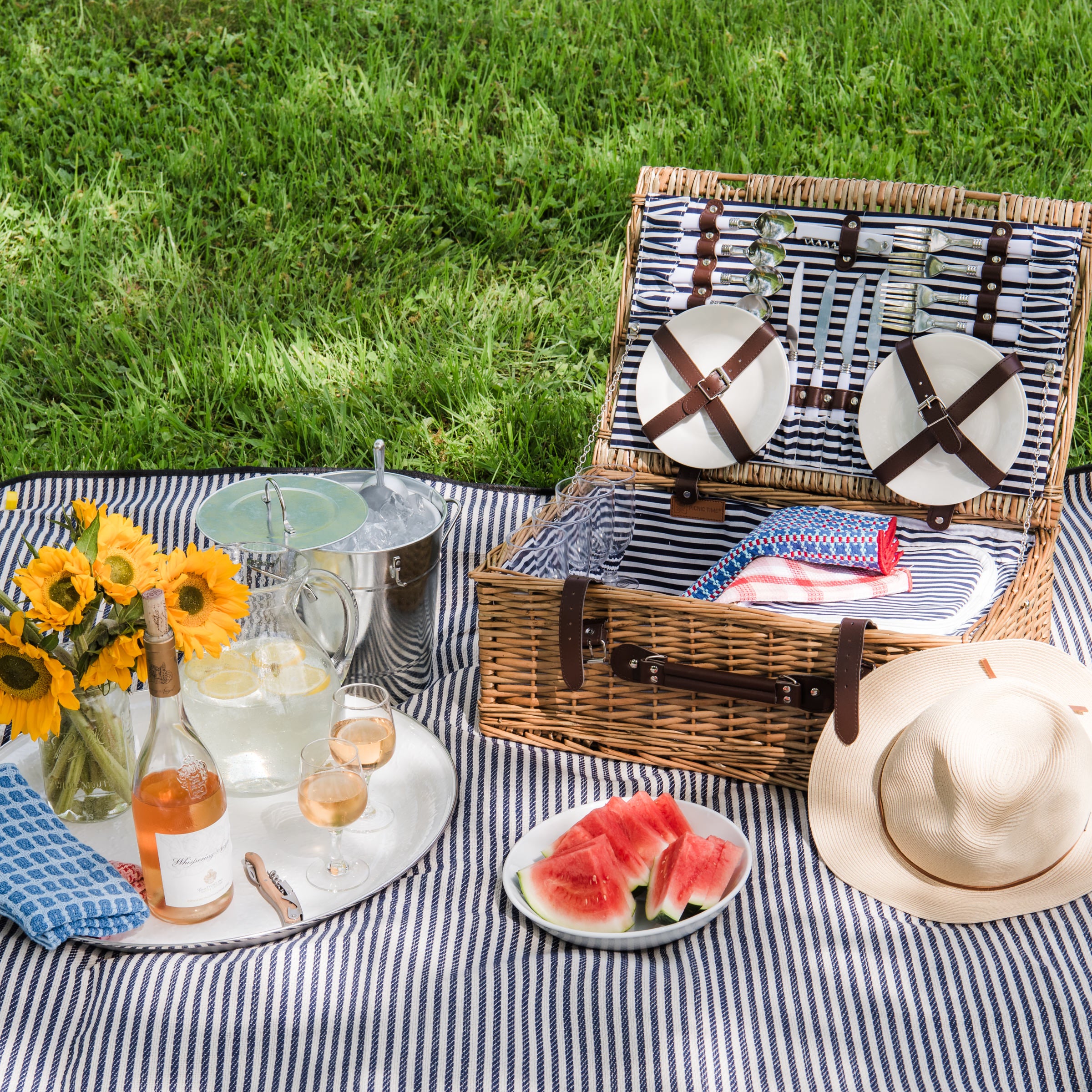 Covington Classic Willow Four Person Picnic Basket on a picnic blanket with a model at Addison West