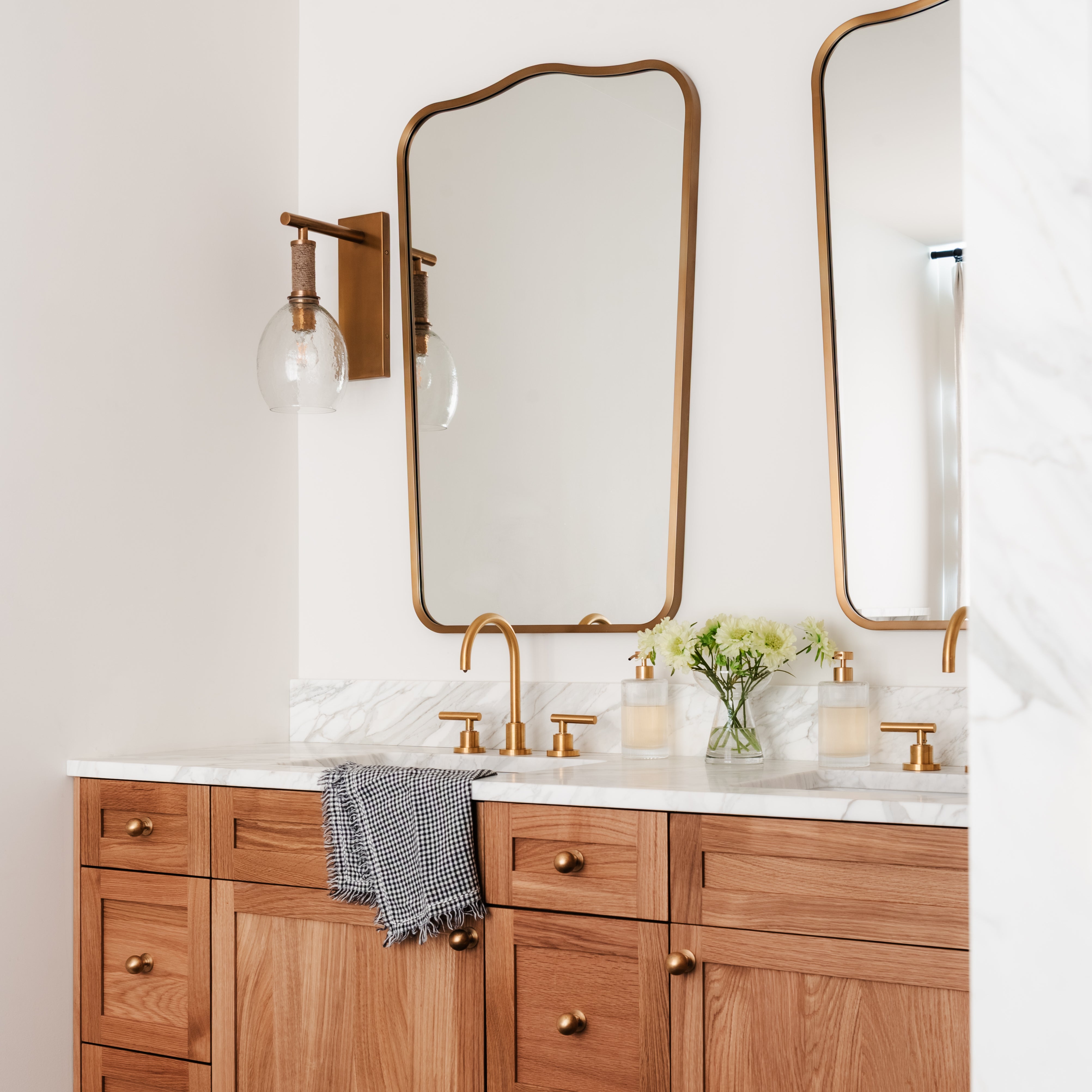 Palecek Bronson Sconce In Brass in a bathroom at Addison West