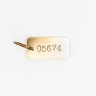 05674 Rectangular Brass Key Ring on a white background at Addison West
