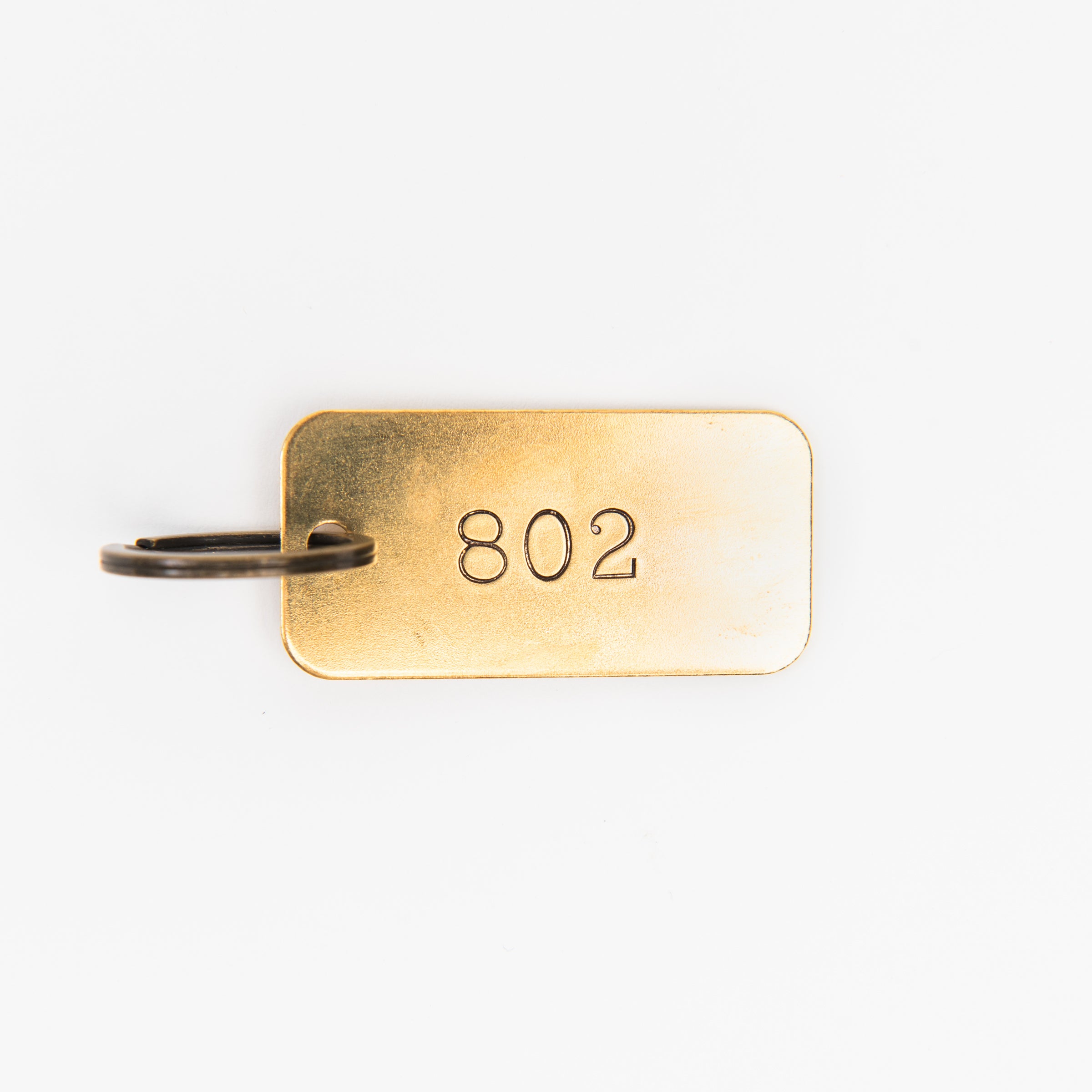 802 Rectangular Brass Key Ring on a white background at Addison West