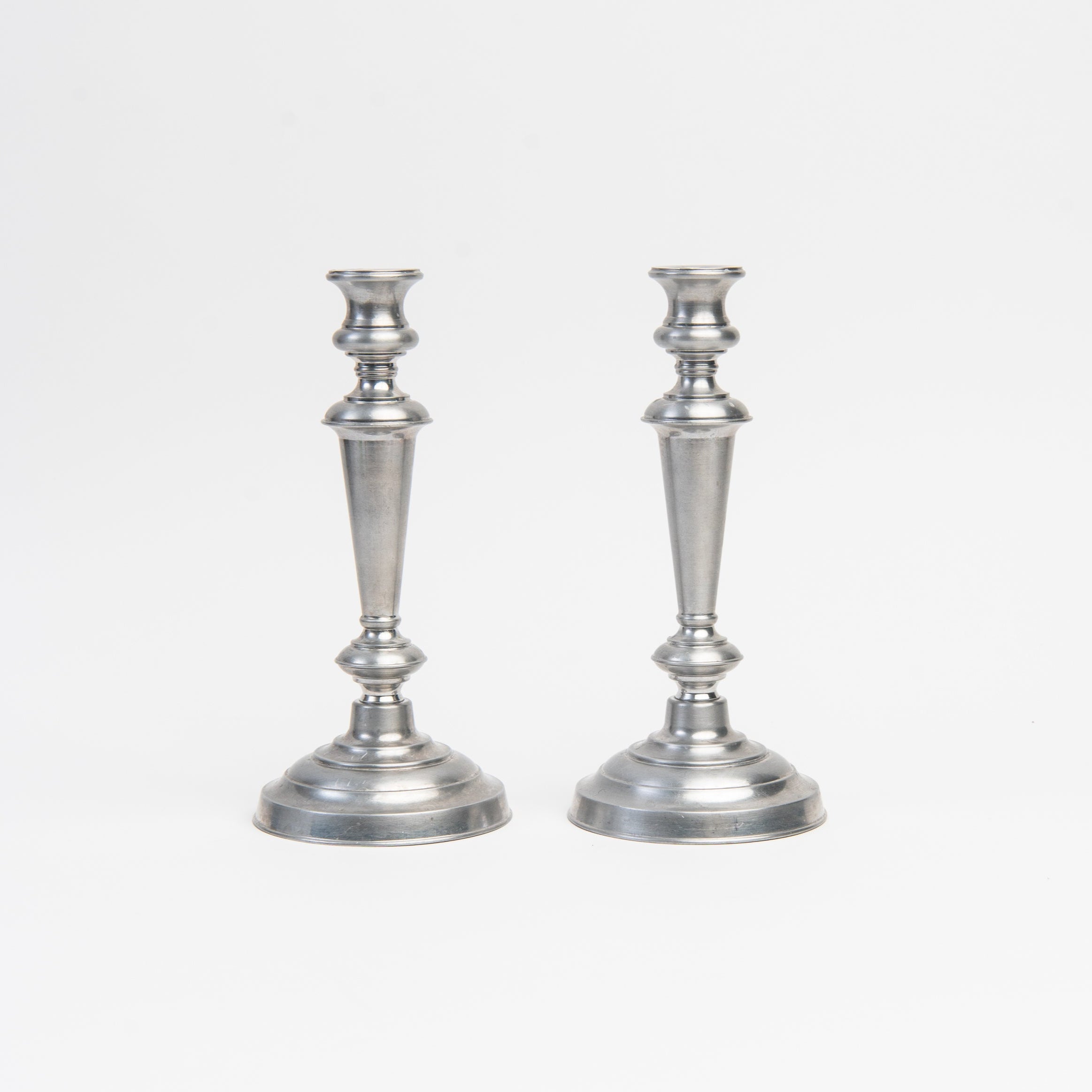 Vintage Wilton Tall Pewter Candlesticks on a white background at Addison West