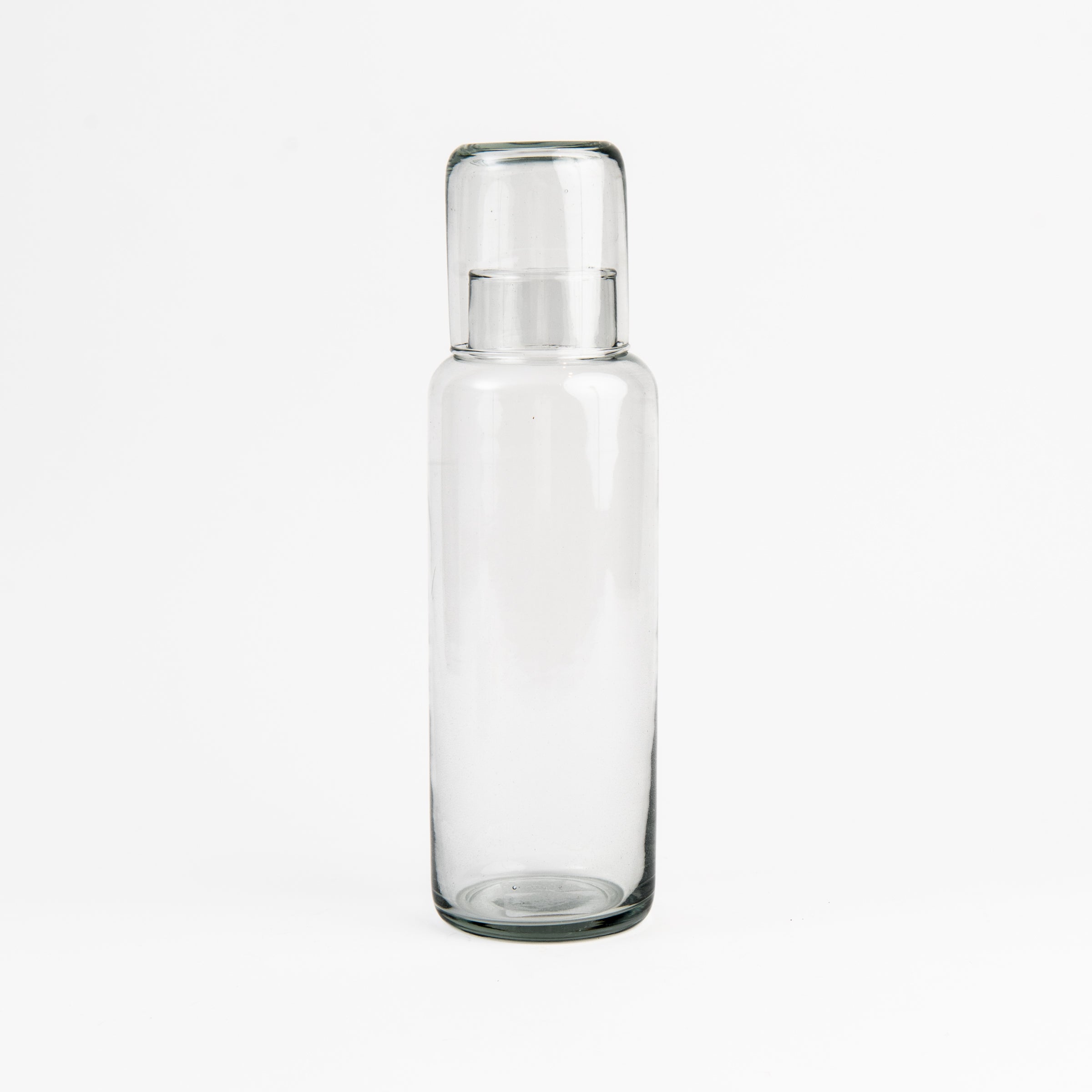 Recycled Glass Decanter with Drinking Glass on a white background at Addison West