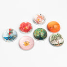 Collection of Saint Austin Company paperweights on a white background at Addison West