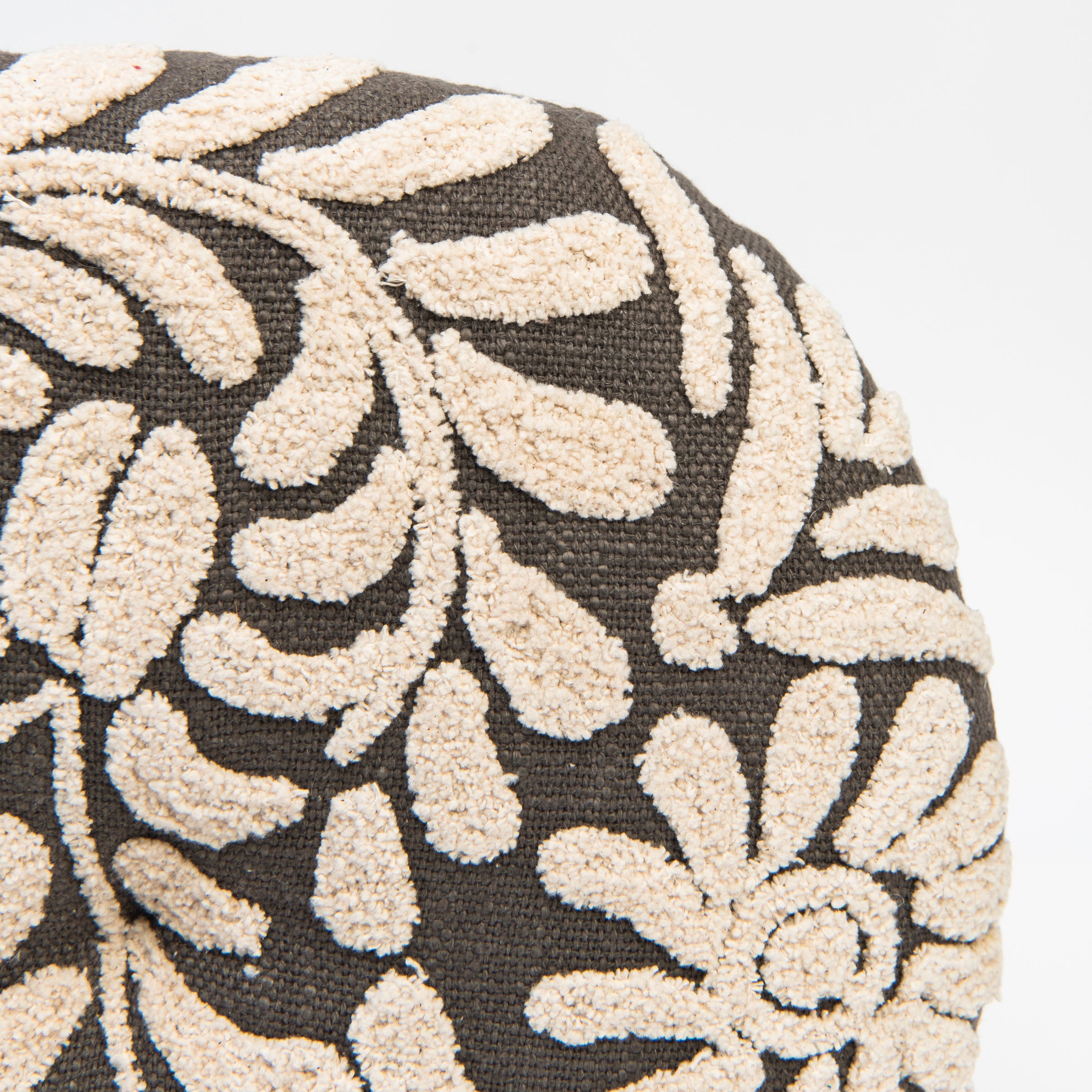 Close up of Wildflower Round Pillow in Charcoal on a white background at Addison West