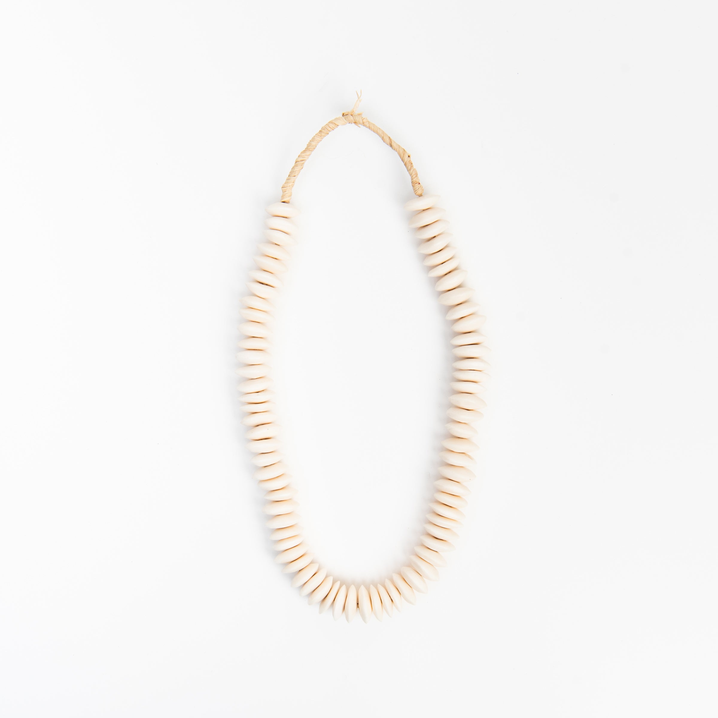 Saucer White Bone Beads on a white background at Addison West