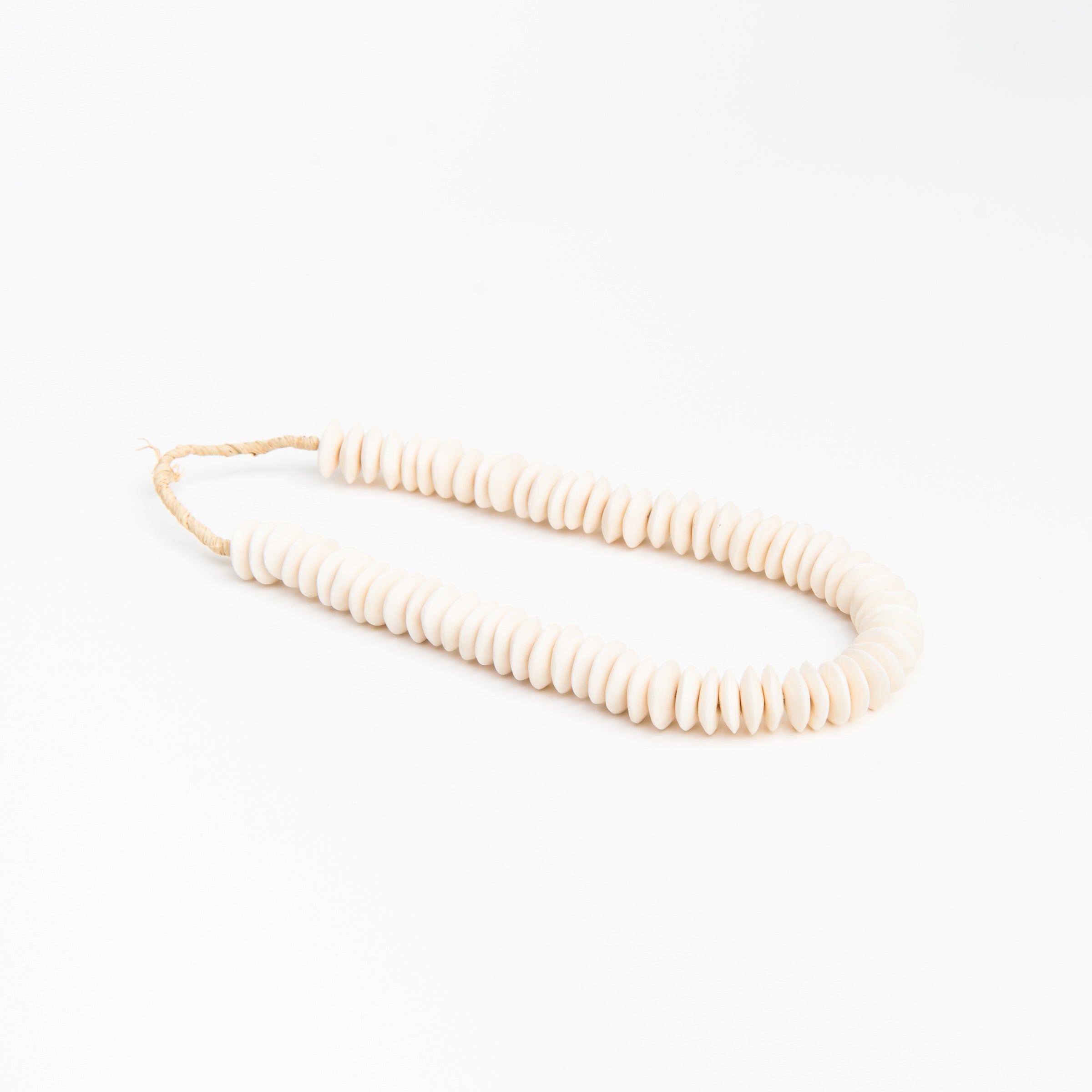 Saucer White Bone Beads on a white background at Addison West