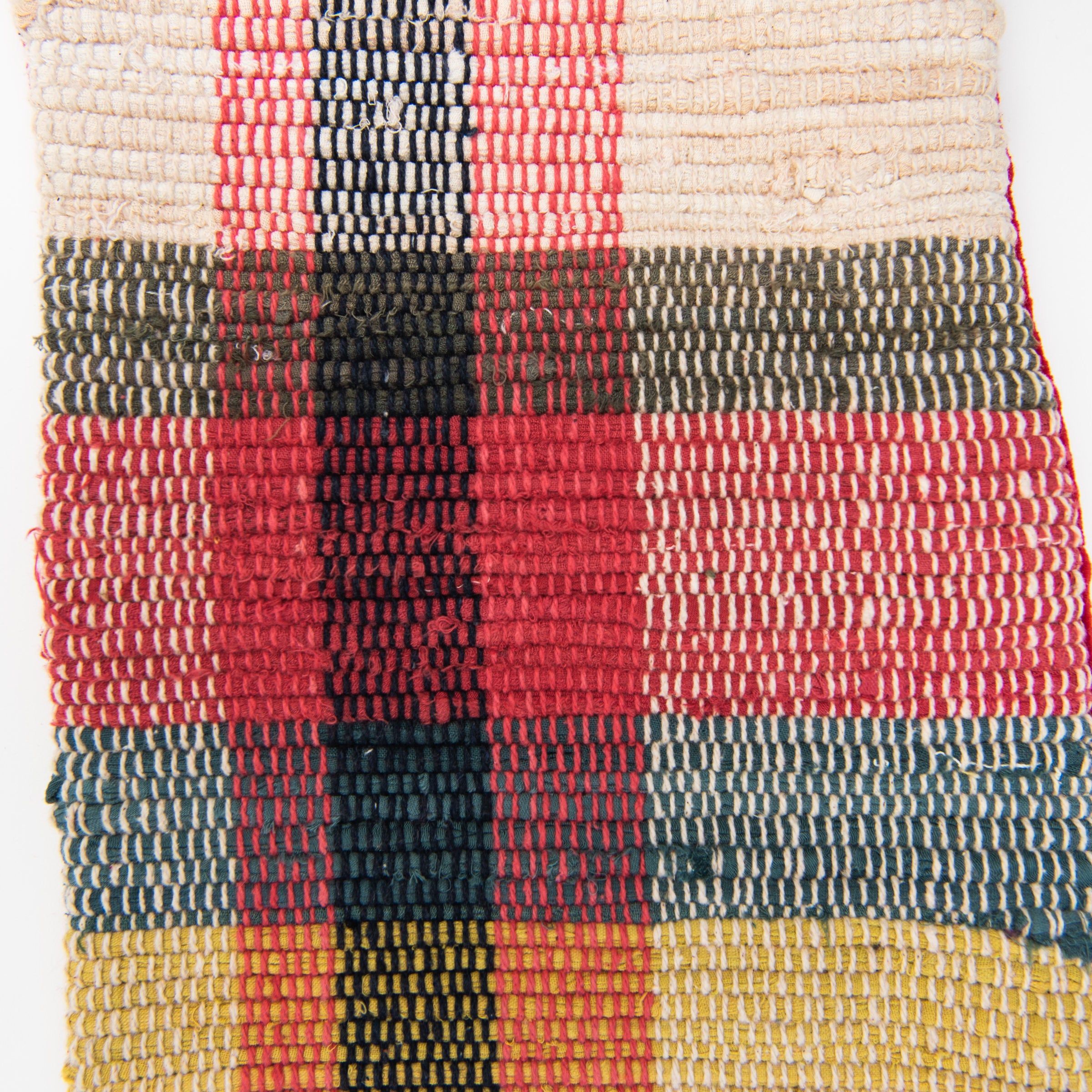 Close up of Hand-Woven Plaid Stocking on a white background at Addison West