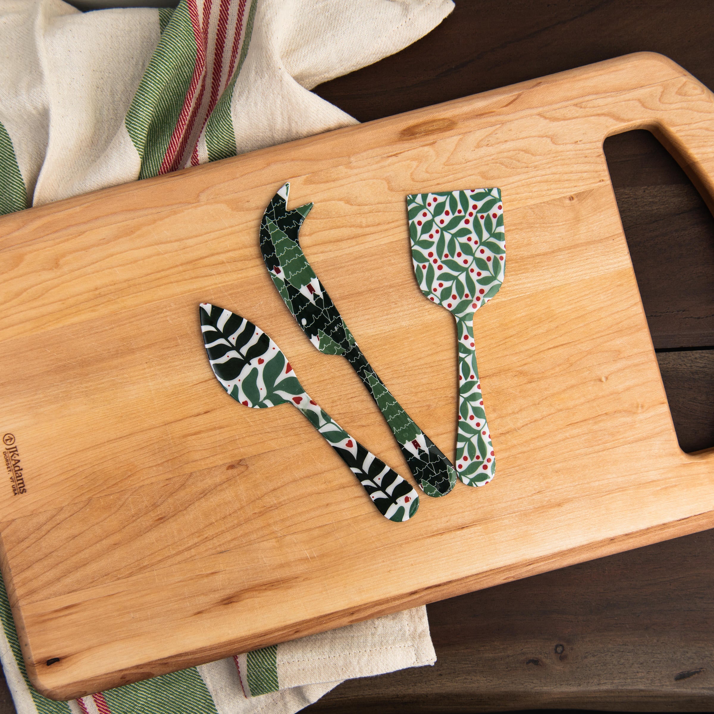 Enameled Holiday Cheese Set on a cutting board at Addison West