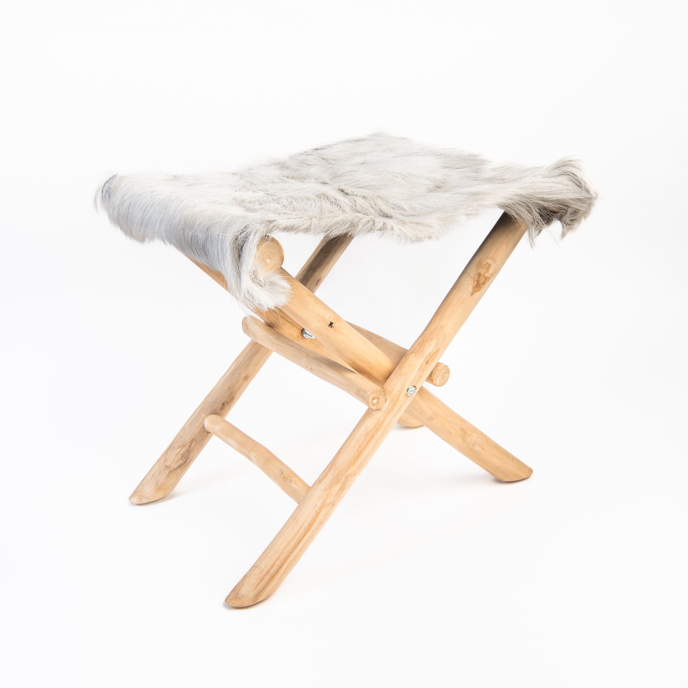 Teakwood and Goat Fur Folding Stool on a white background at Addison West