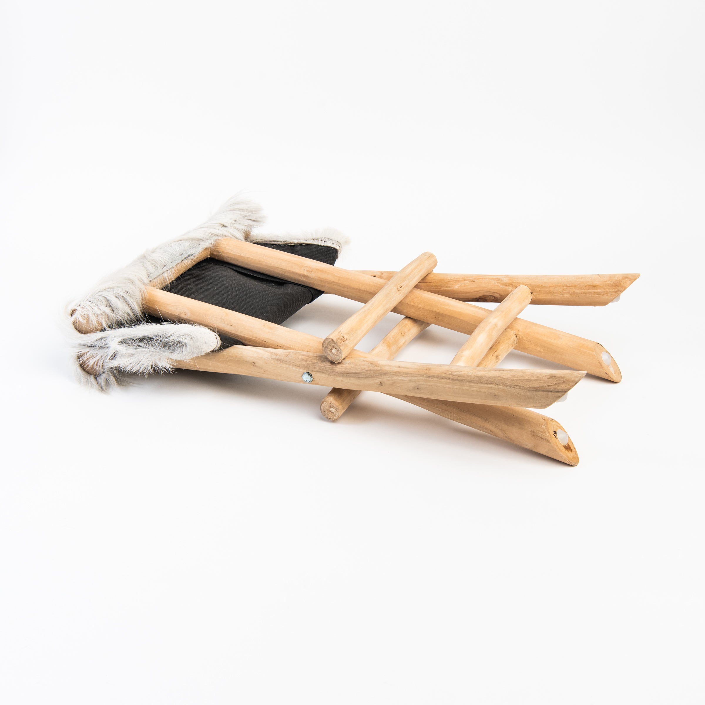 Teakwood and Goat Fur Folding Stool on a white background at Addison West