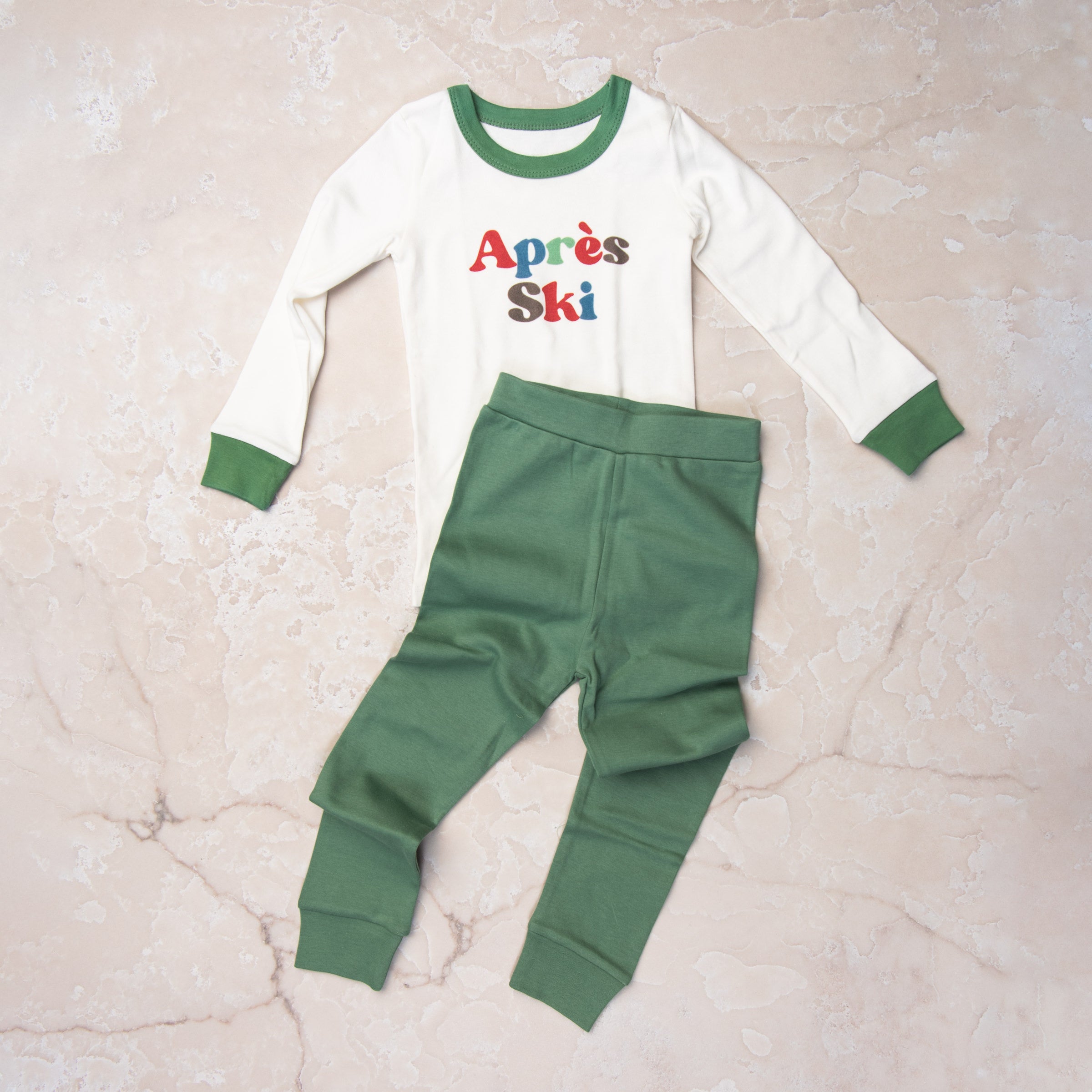 Apres Ski Organic Cotton Toddler PJs on a marble table at Addison West