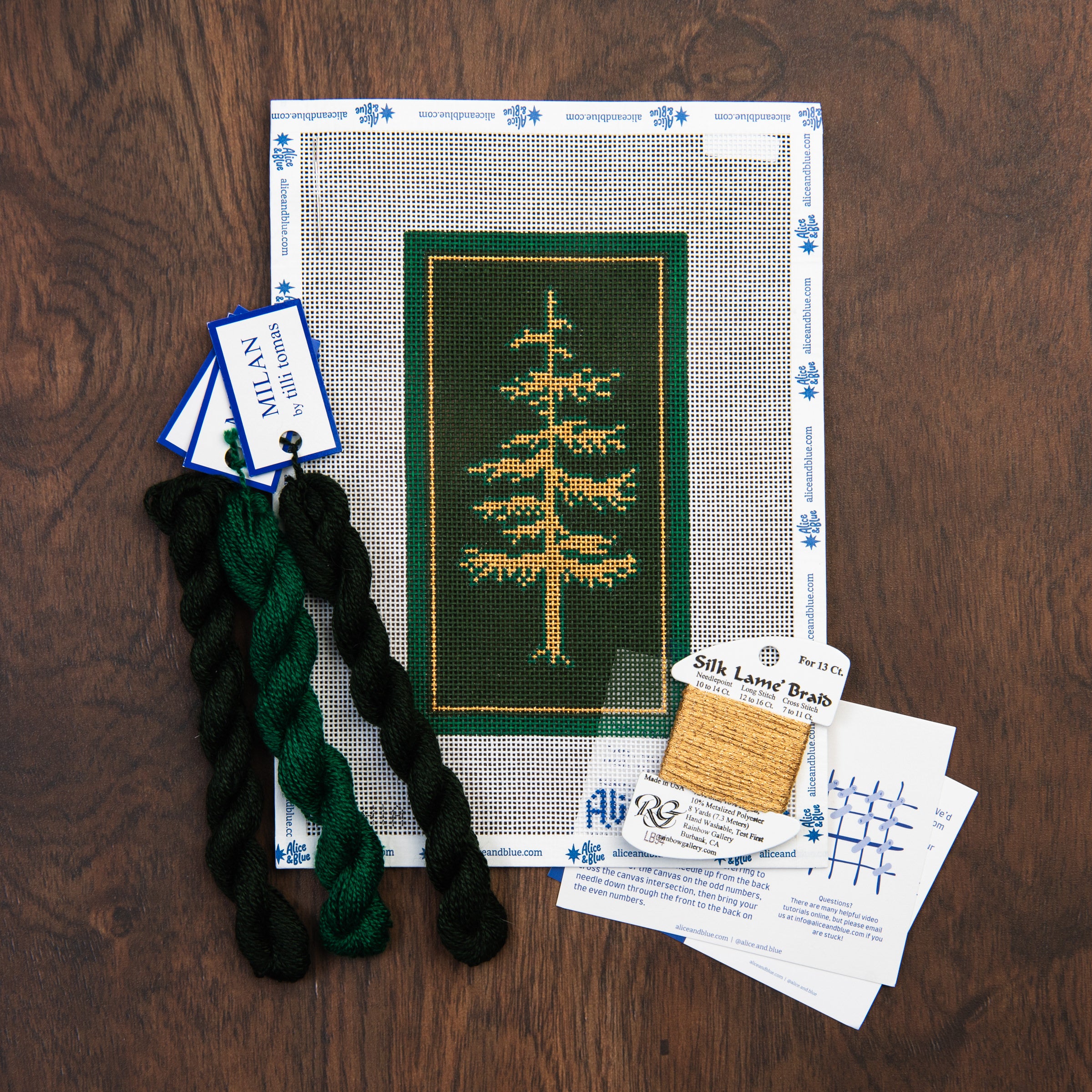 Golden Evergreen Needlepoint Kit on a wood table at Addison West