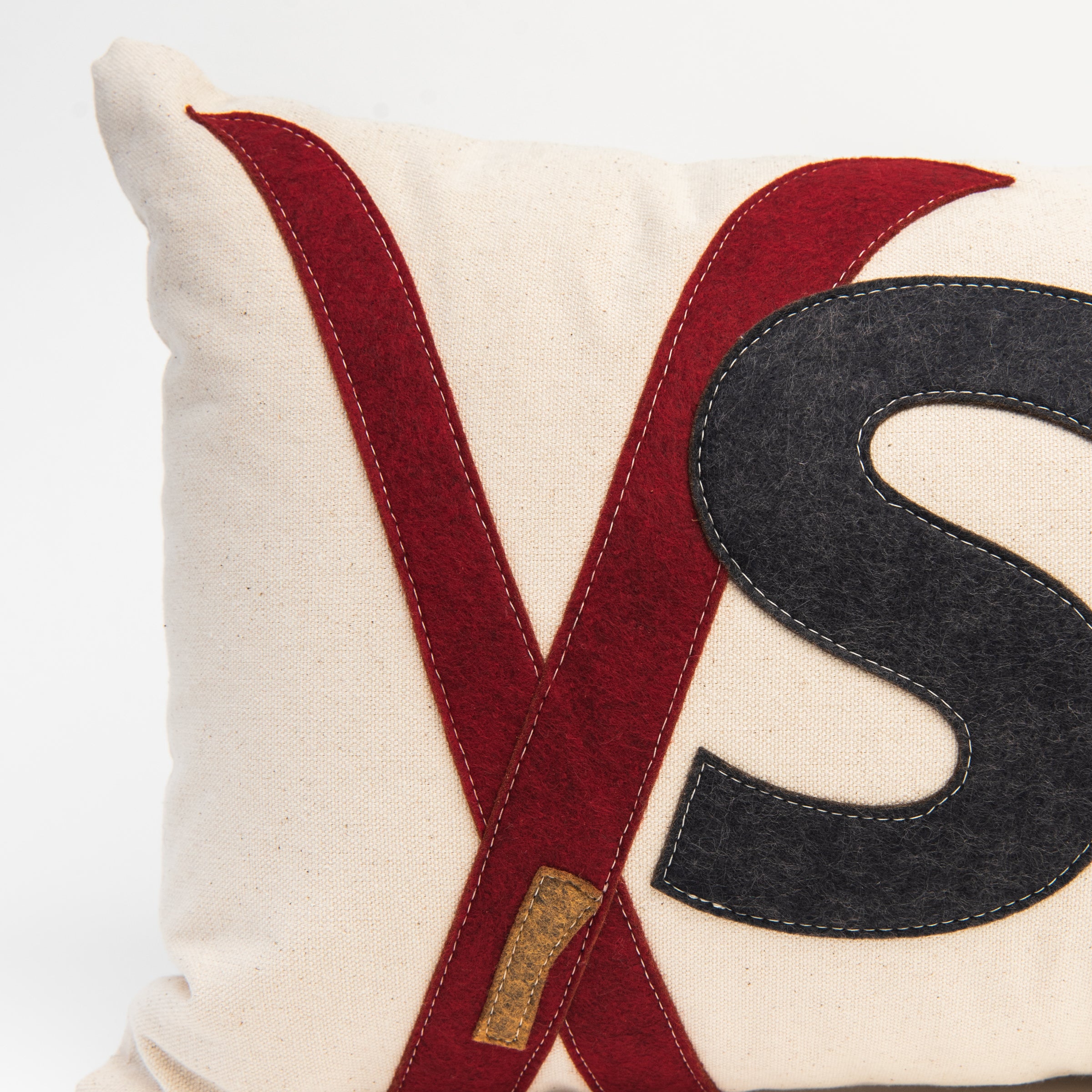 Close up of Red Crossed Ski Lumbar Pillow on a white background at Addison West