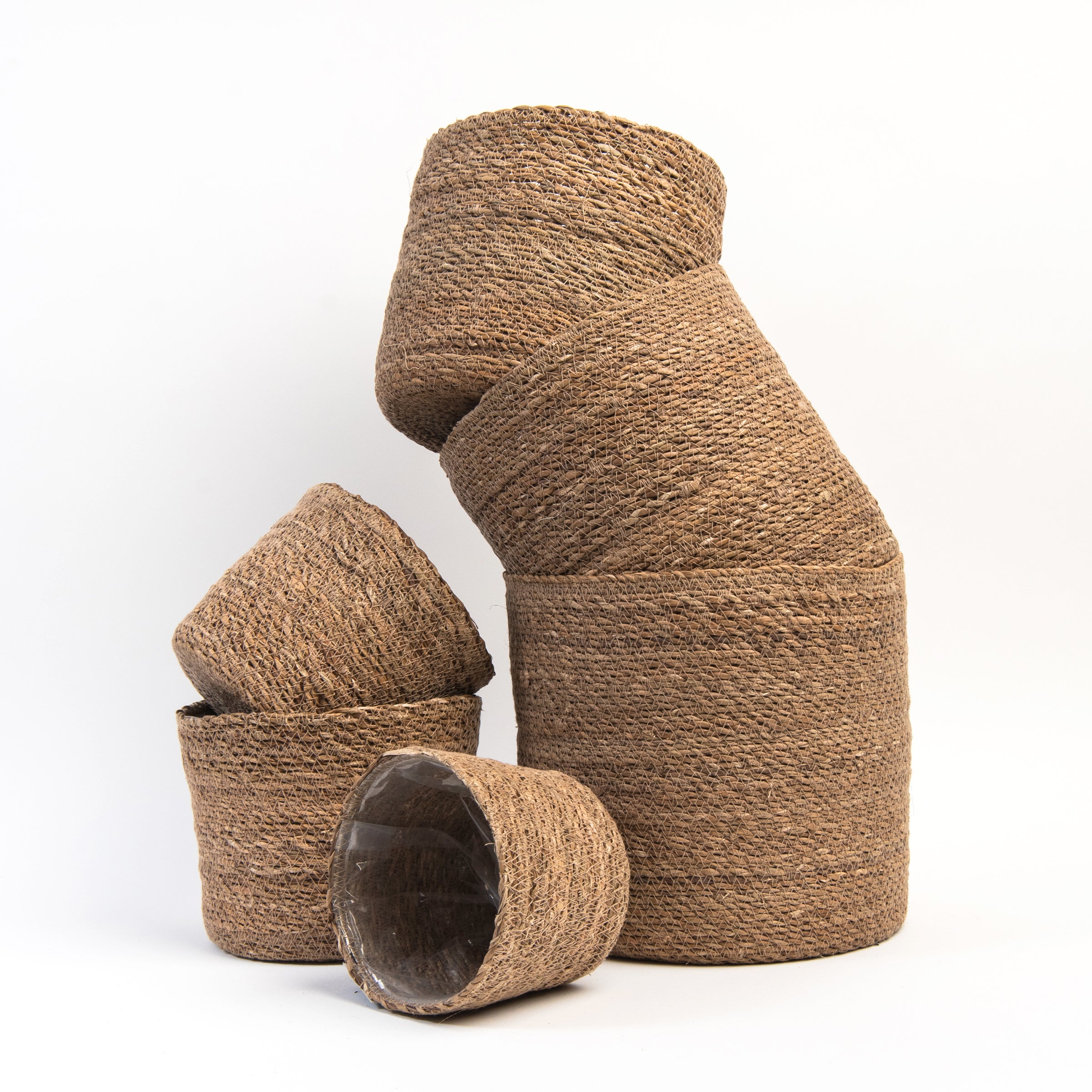 Hand-Woven Baskets with Plastic Lining on a white background at Addison West