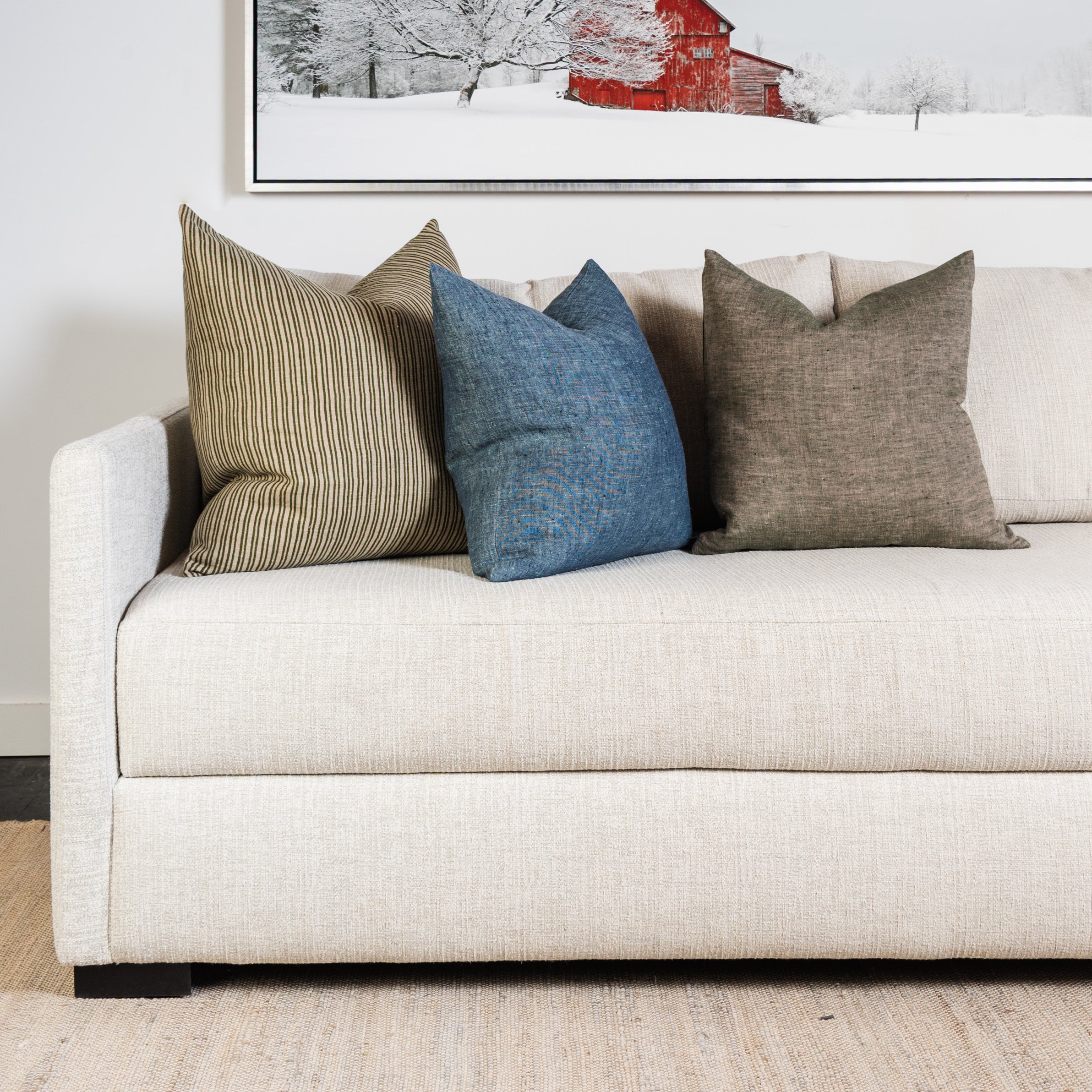 20" Linen Chambray Pillow in Denim and green on a sofa at Addison West