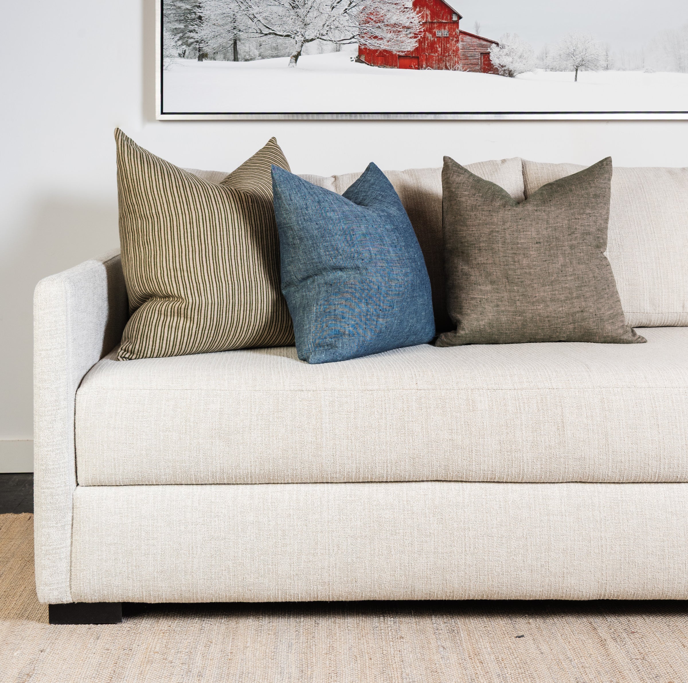 20" Linen Chambray Pillow in Denim and green on a sofa at Addison West