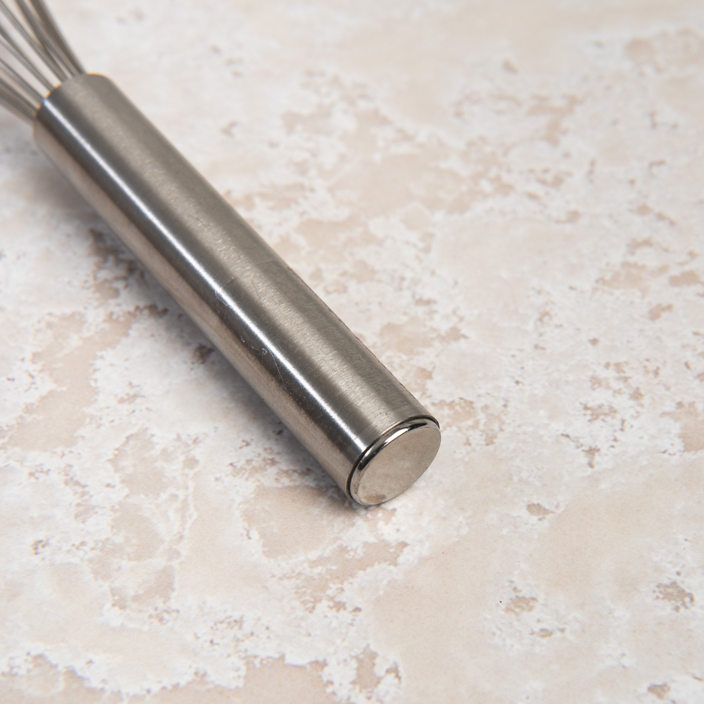 9.5 Inch Ballon Whisk on a beige background at Addison West