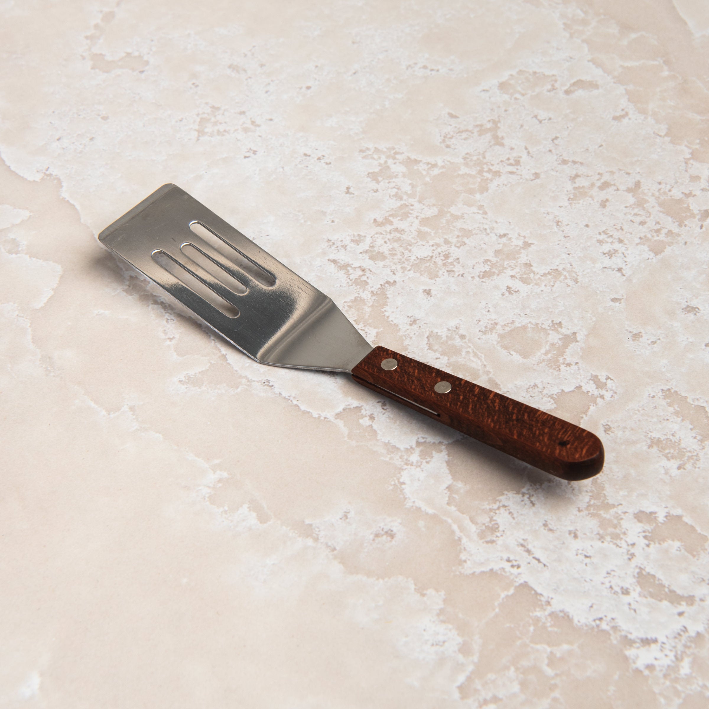 Brownie Spatula on a beige background at Addison West