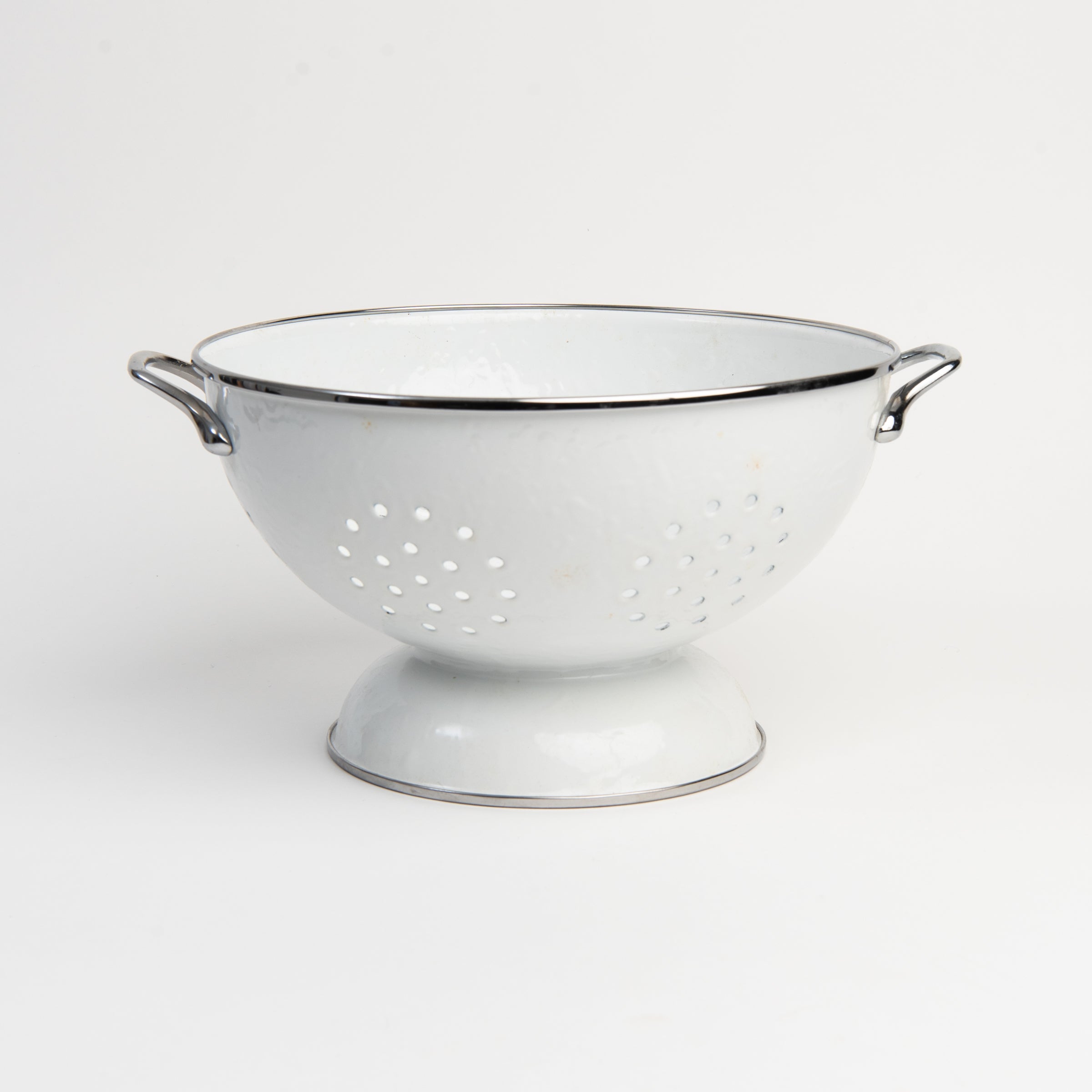 Medium White Enamelware Colander on a white background at Addison West