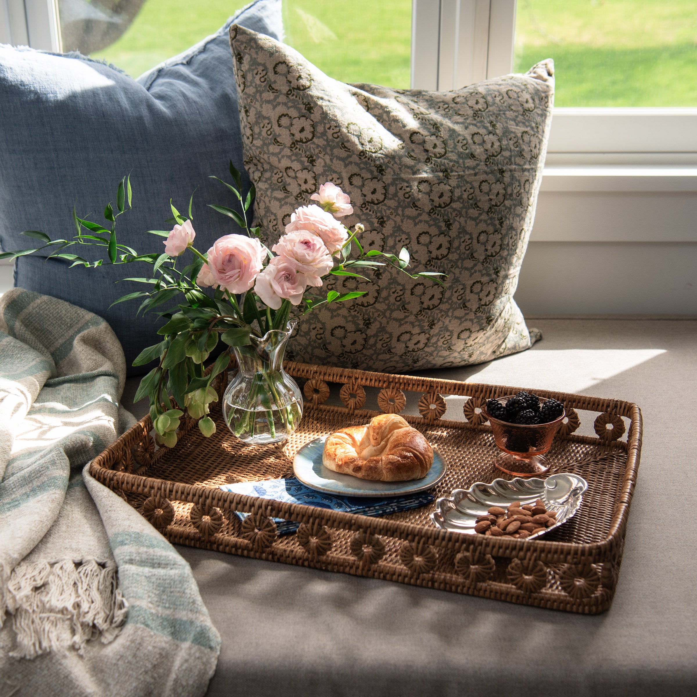 Tulum Striped Throw in Blue, Ingrid Rattan Rectangular Tray, Chelsea Optic Posy Vase, on a window seat at Addison West
