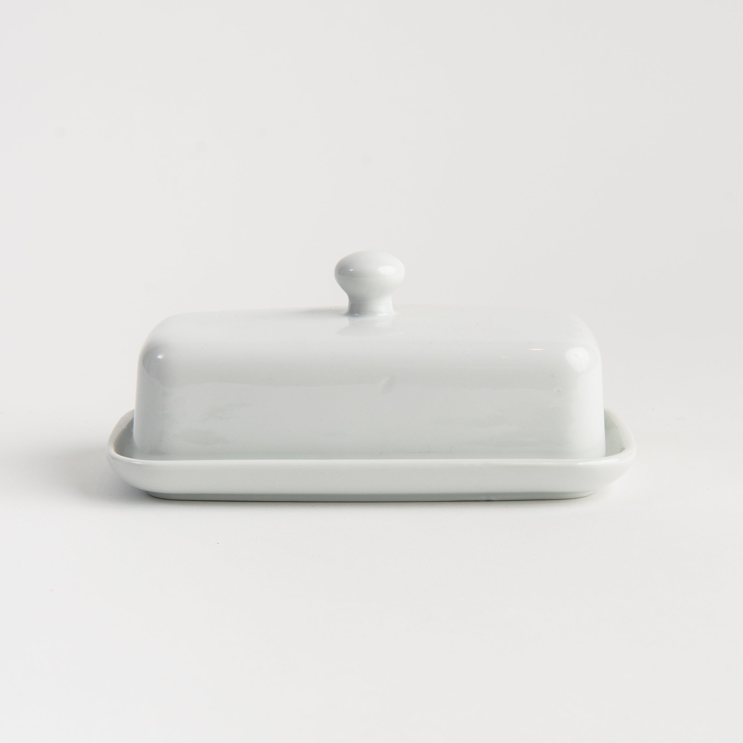 White Porcelain Butter Dish with Knob Handle on a white background at Addison West