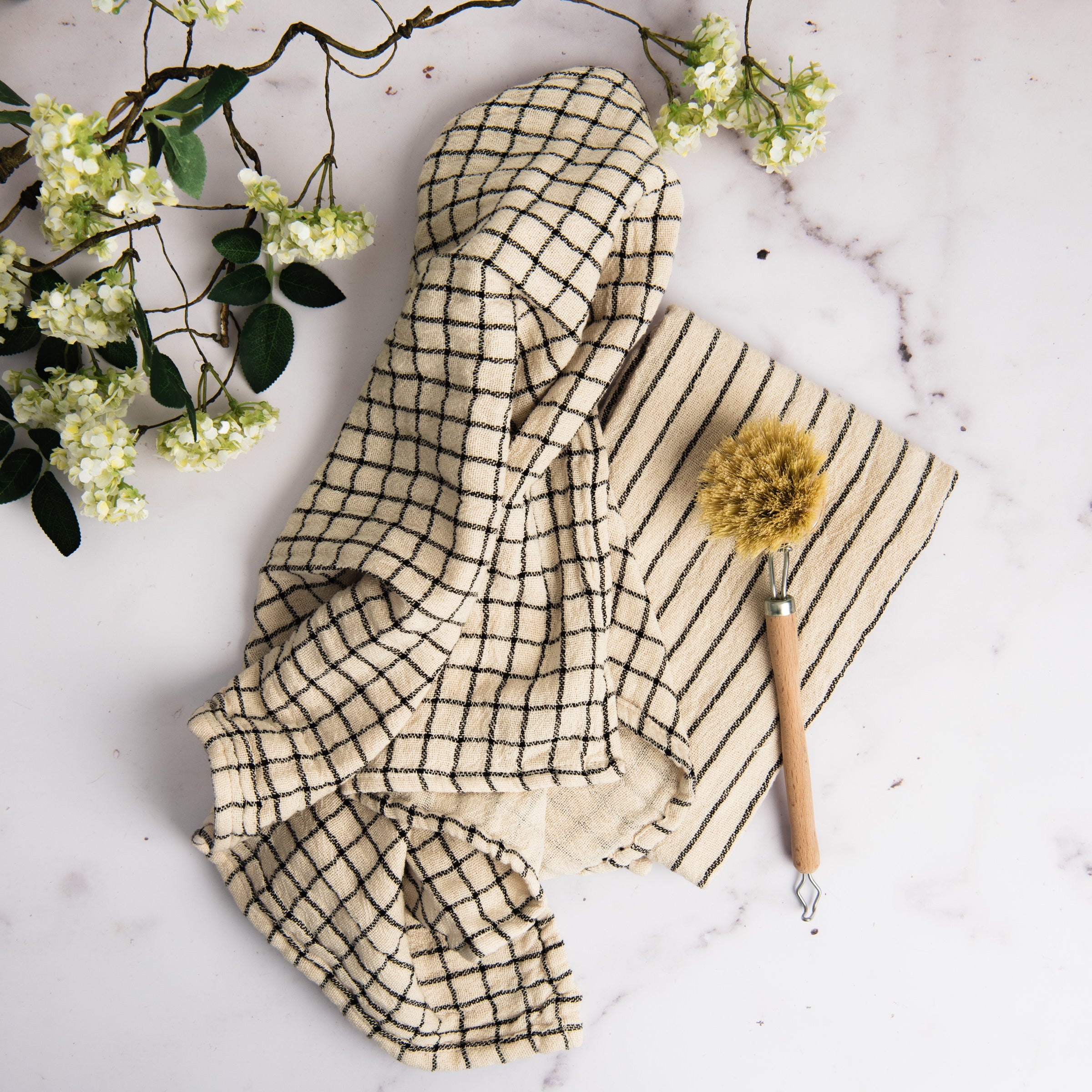 Farmstand Cotton Tea Towel on a marble table at Addison West