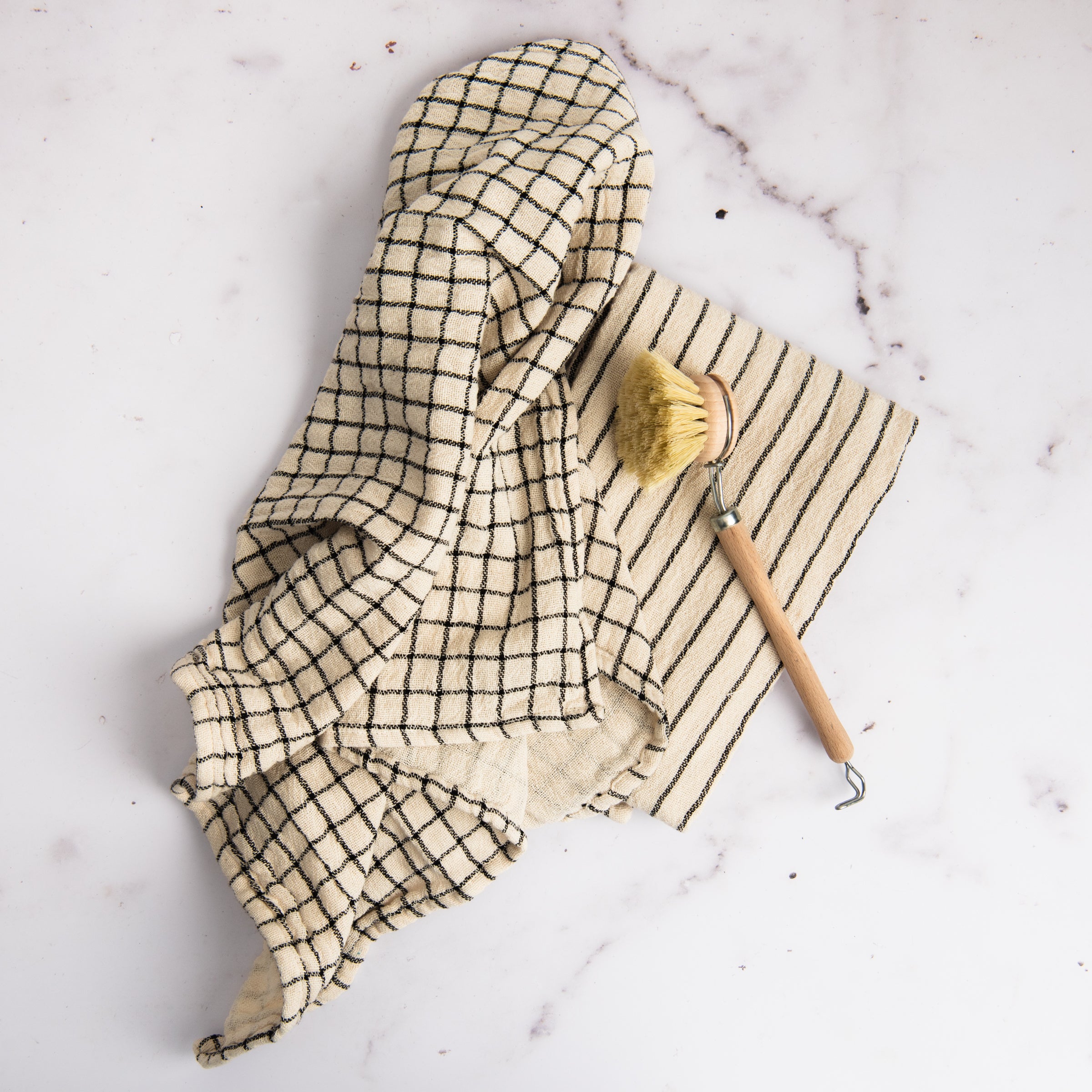 Farmstand Cotton Tea Towel on a marble table at Addison West