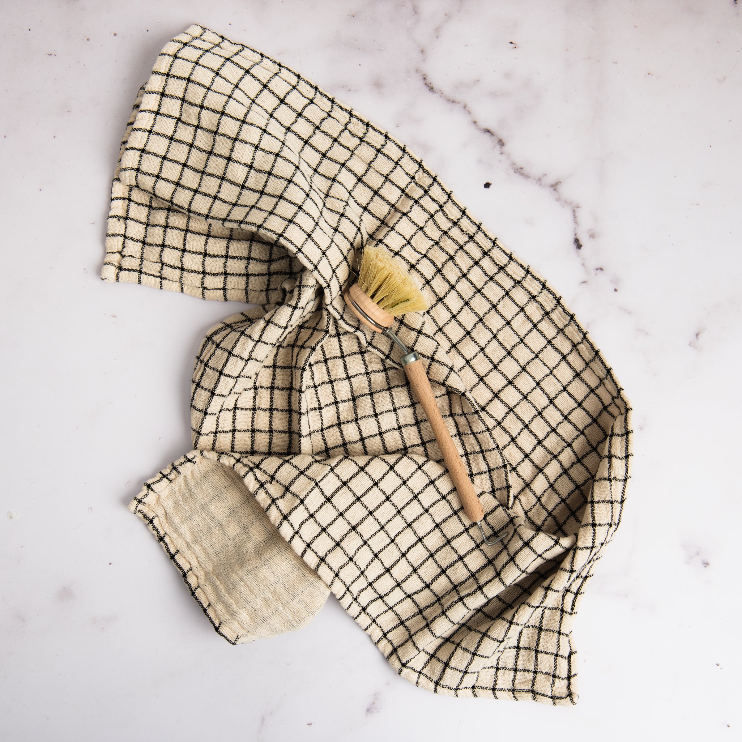 Farmstand Cotton Tea Towel on a marble table at Addison West
