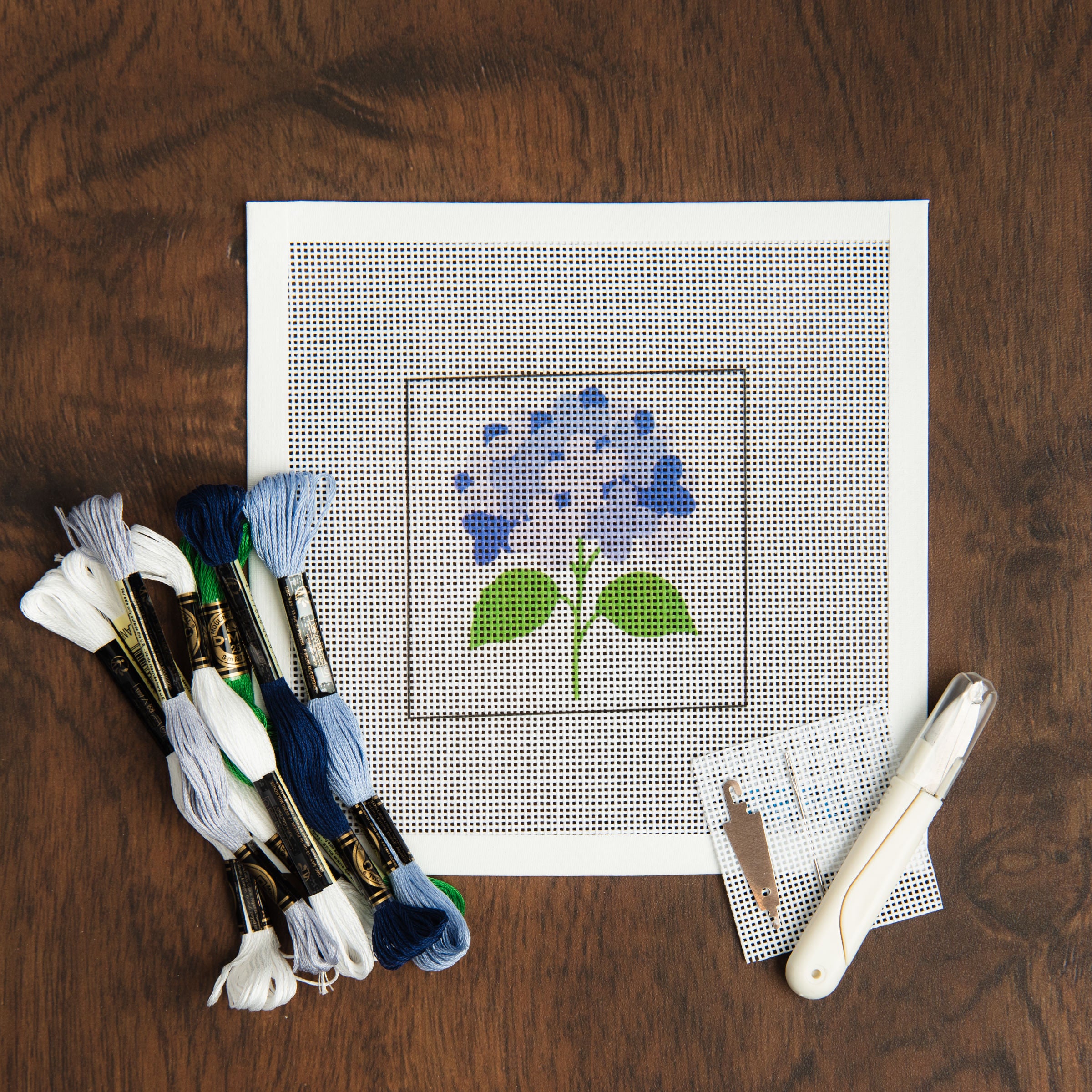 Blue Hydrangea Needlepoint Kit on a table at Addison West