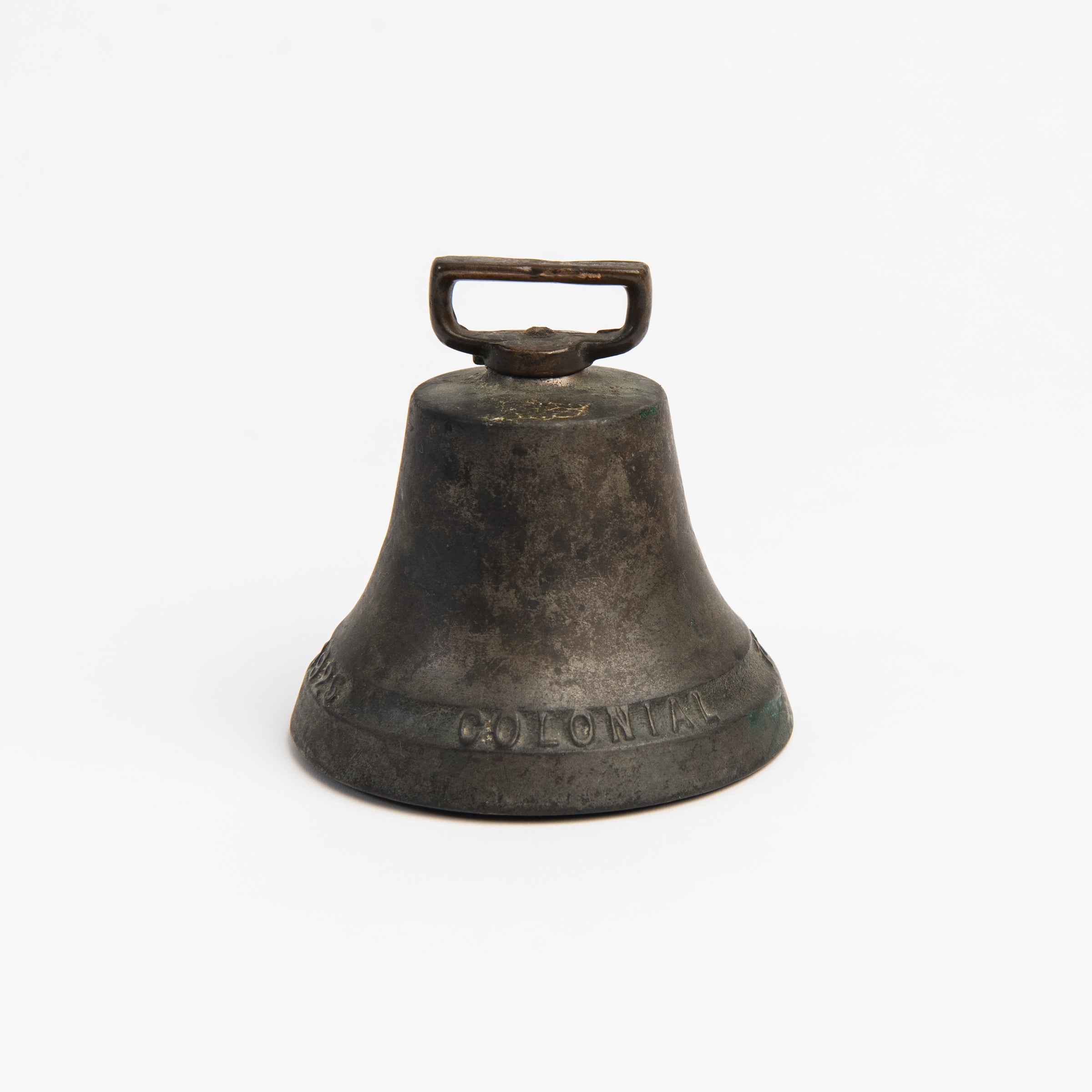 Vintage Bronze Colonial Bell on a white background at Addison West