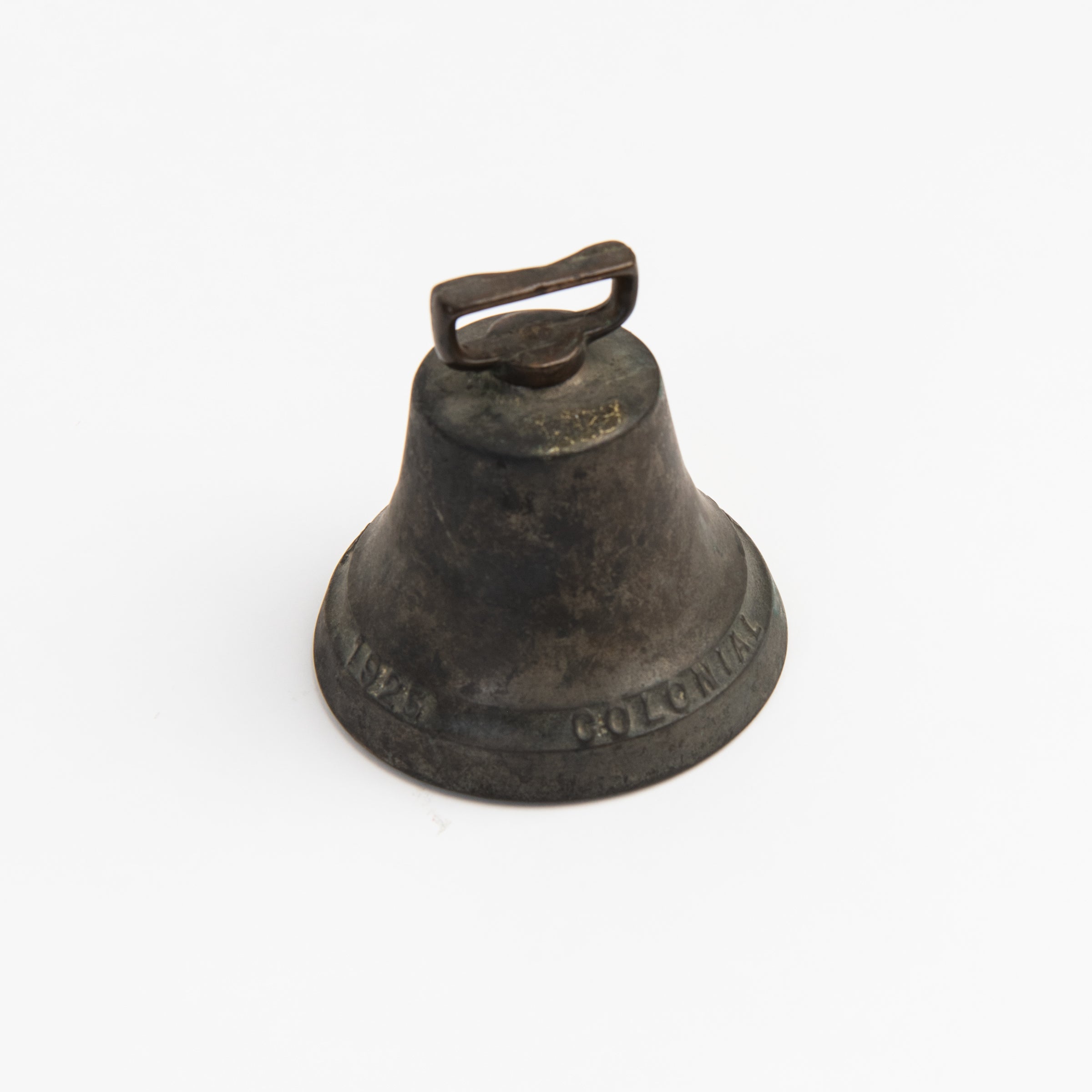 Vintage Bronze Colonial Bell on a white background at Addison West