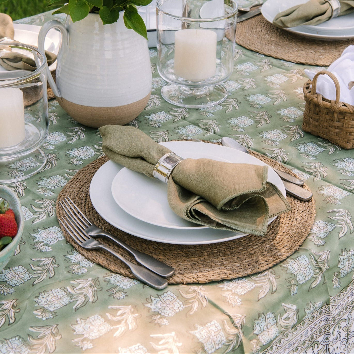 Classic Pewter Napkin Rings, Set of 4 and Stonewash Forest Linen Napkins, Set of 4n, and Ashton Antique 5 piece Flatware on an outdoor table at Addison West