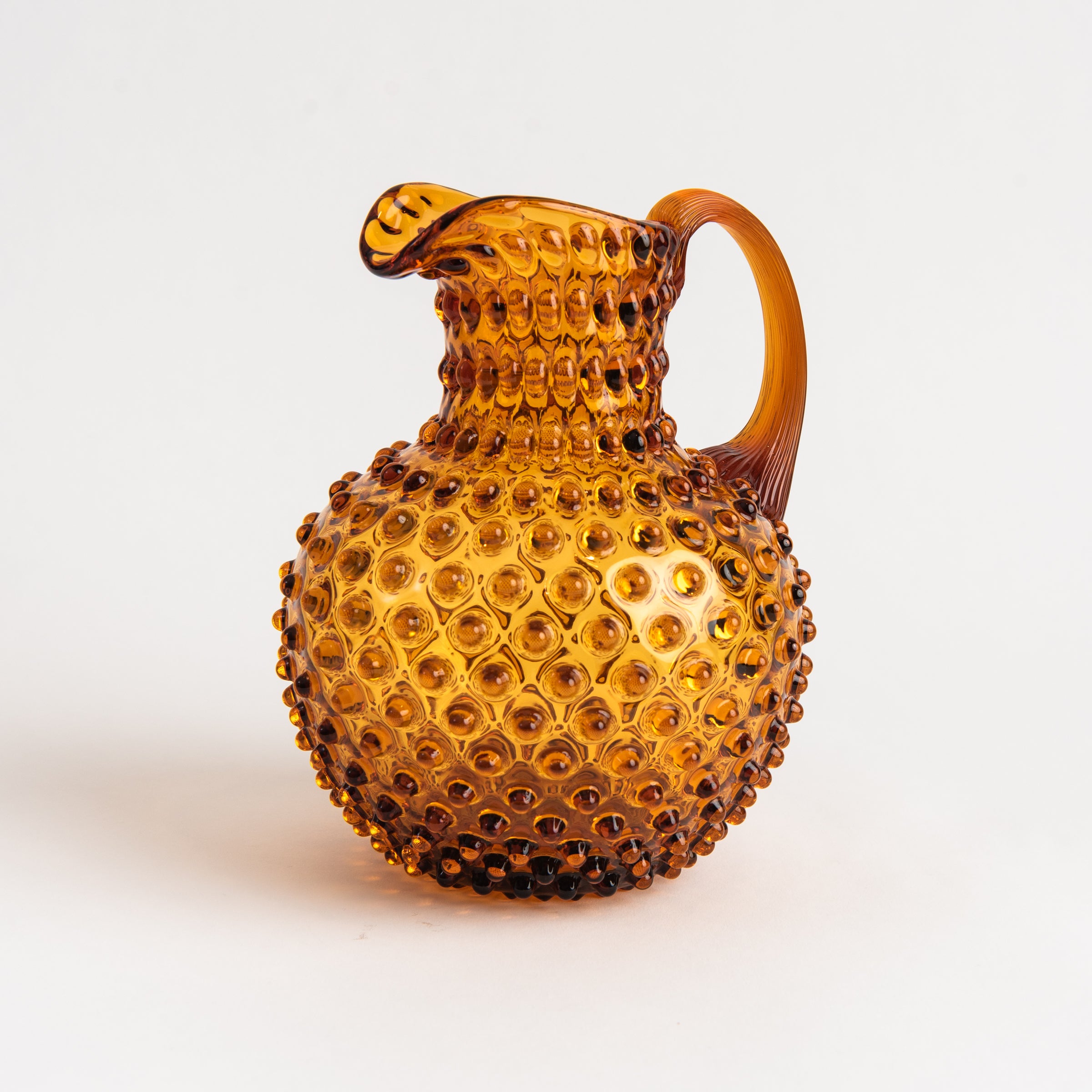 Hobnail Glass Pitcher in Saffron Light on a white background at Addison West