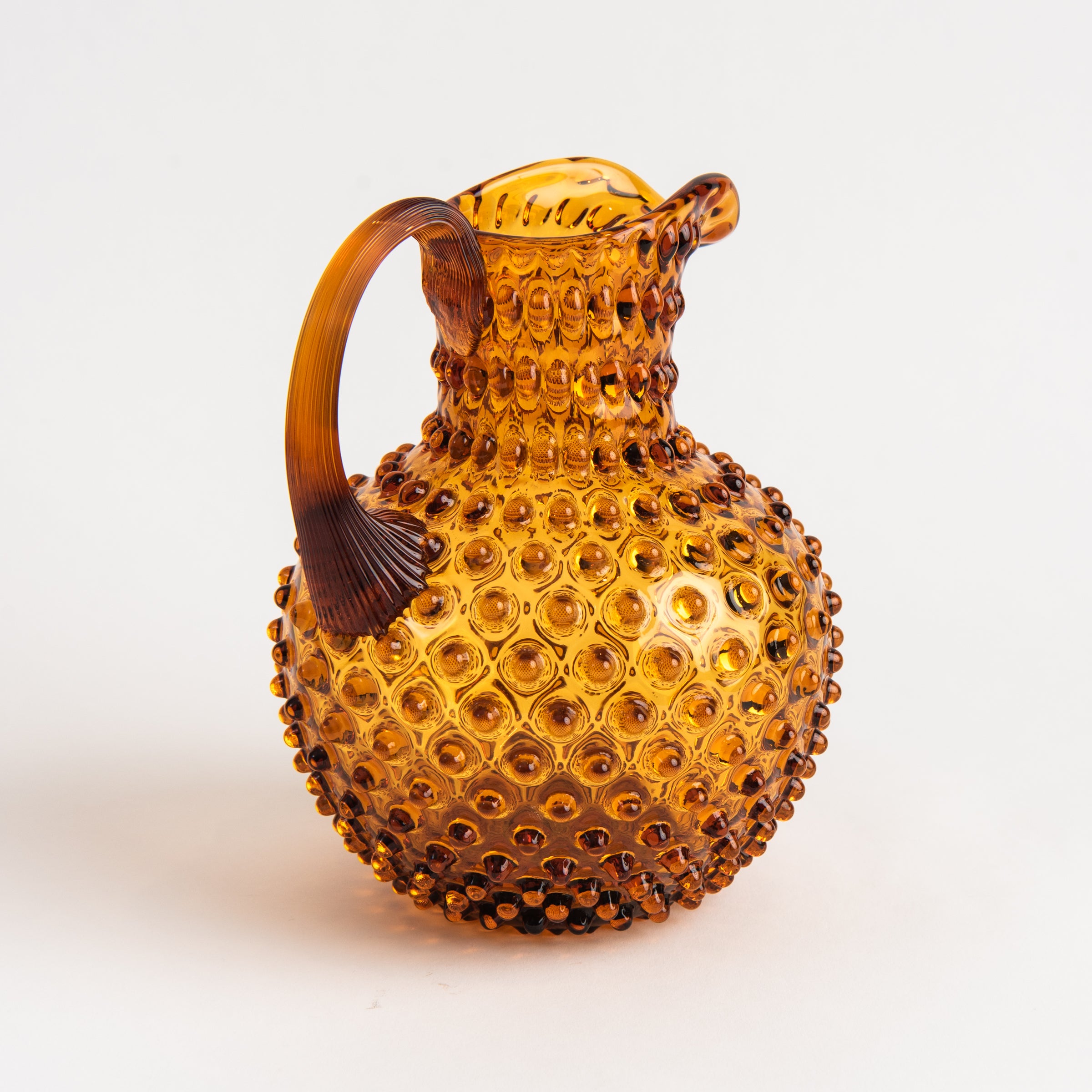 Hobnail Glass Pitcher in Saffron Light on a white background at Addison West