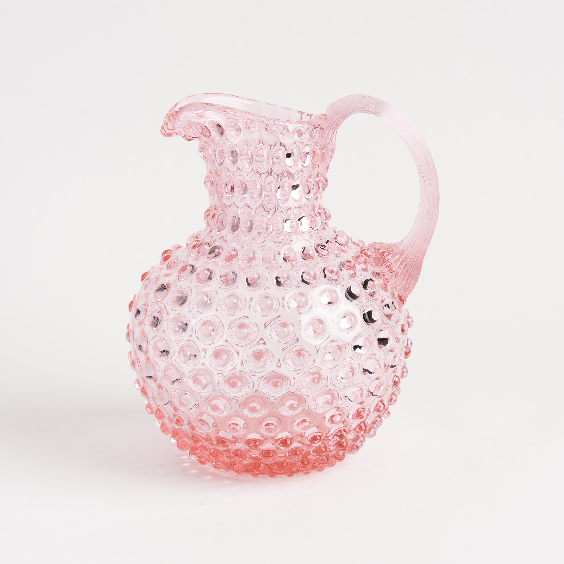 Hobnail Glass Pitcher in Petal Pink on a white background at Addison West