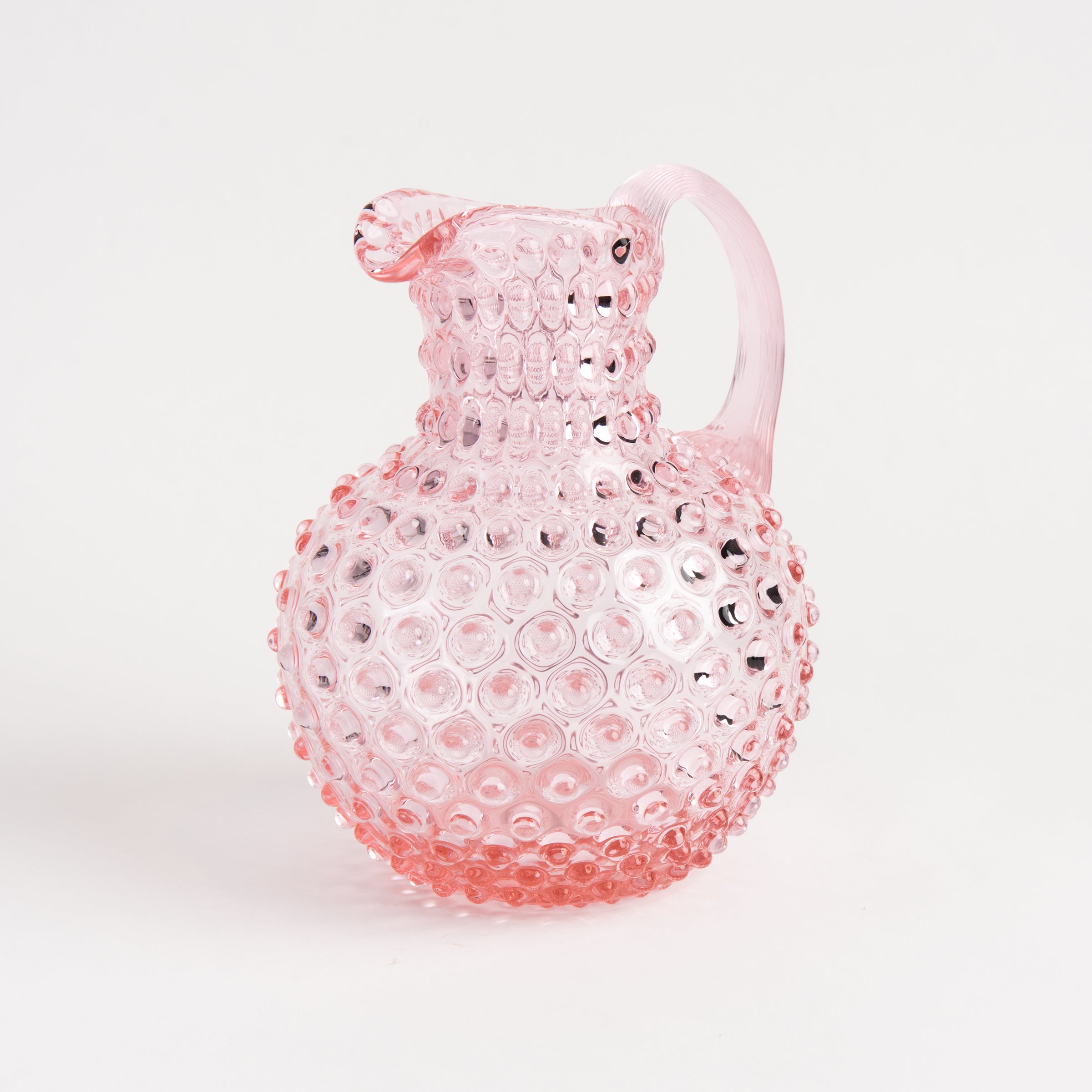 Hobnail Glass Pitcher in Petal Pink on a white background at Addison West