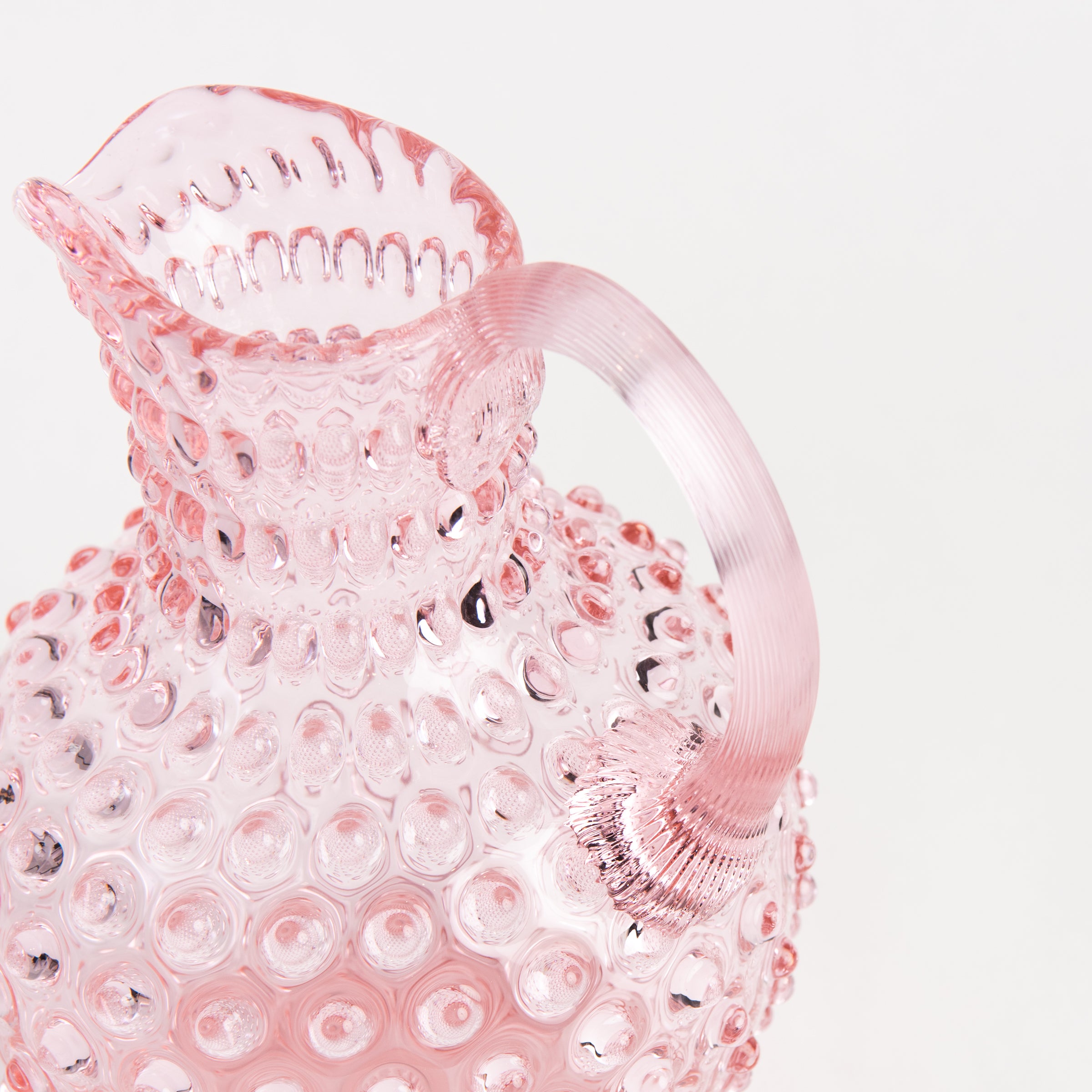 Hobnail Glass Pitcher in Petal Pink on a white background at Addison West