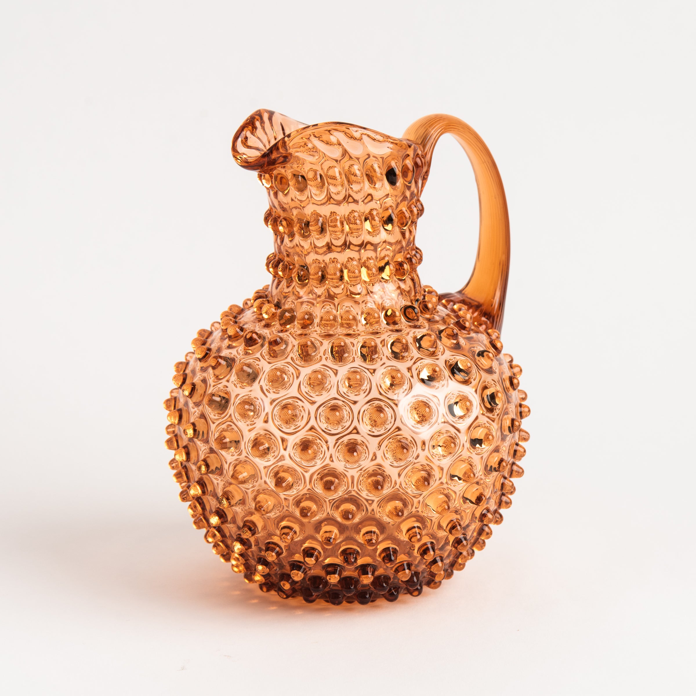 Hobnail Glass Pitcher in Honey Gold on a white background at Addison West