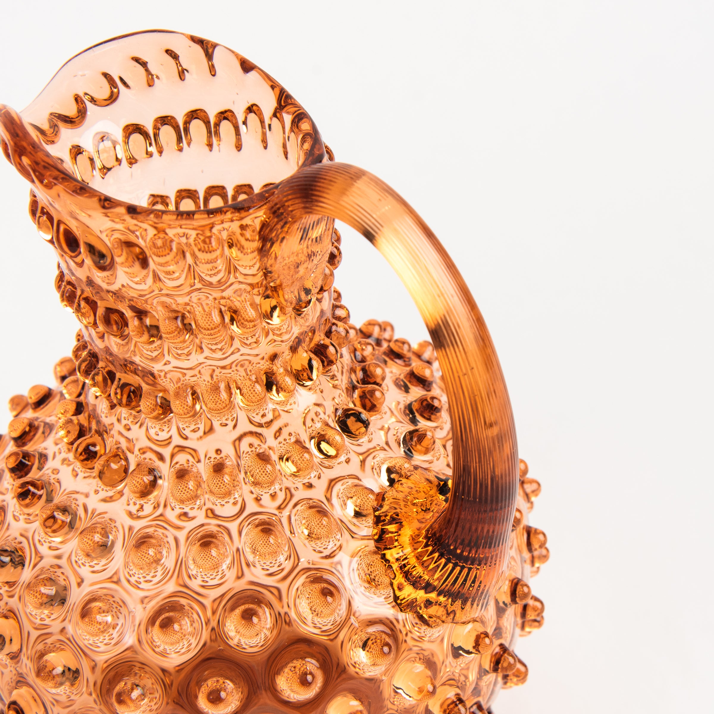 Hobnail Glass Pitcher in Honey Gold on a white background at Addison West