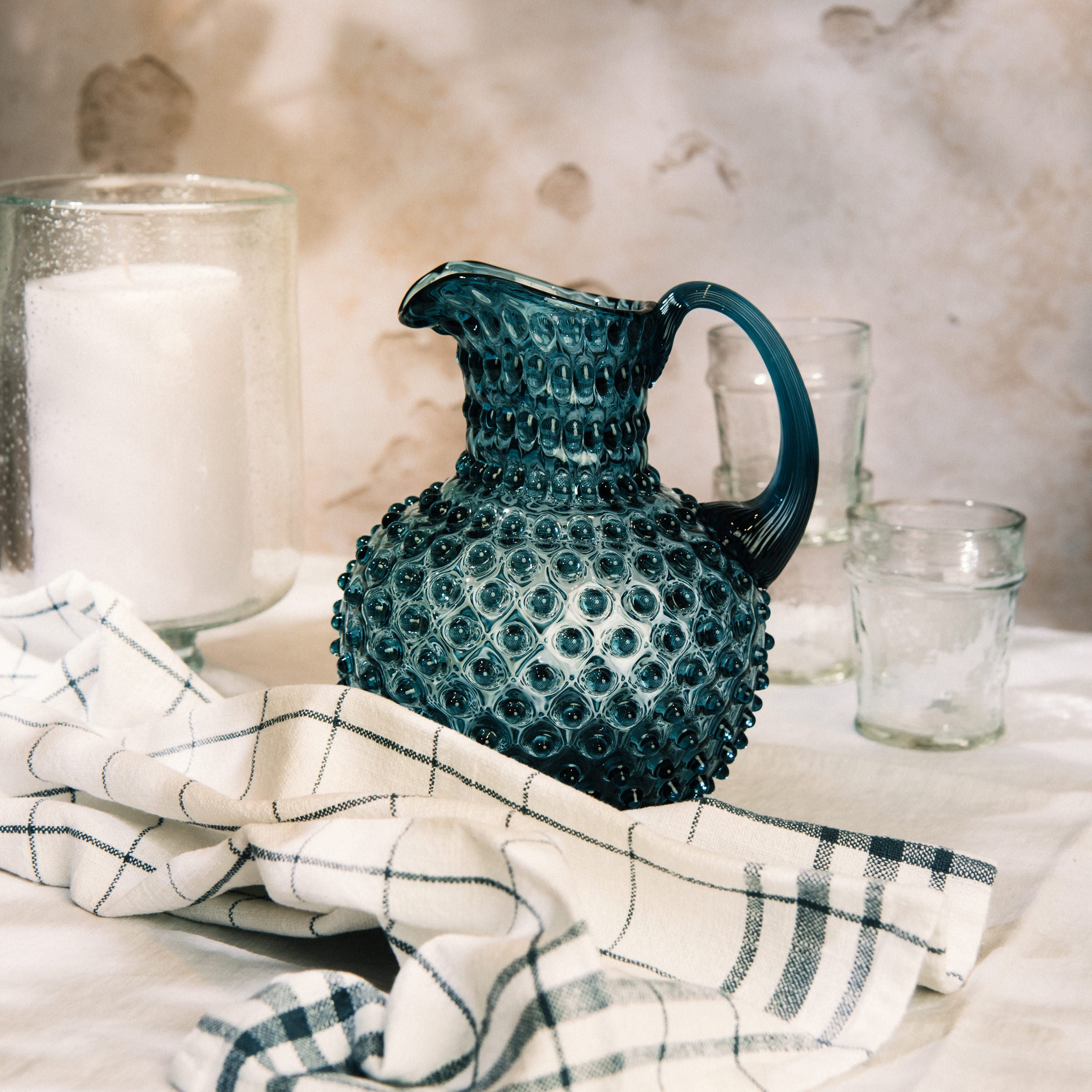 Hobnail Glass Pitcher in Midnight Blue on a table at Addison West